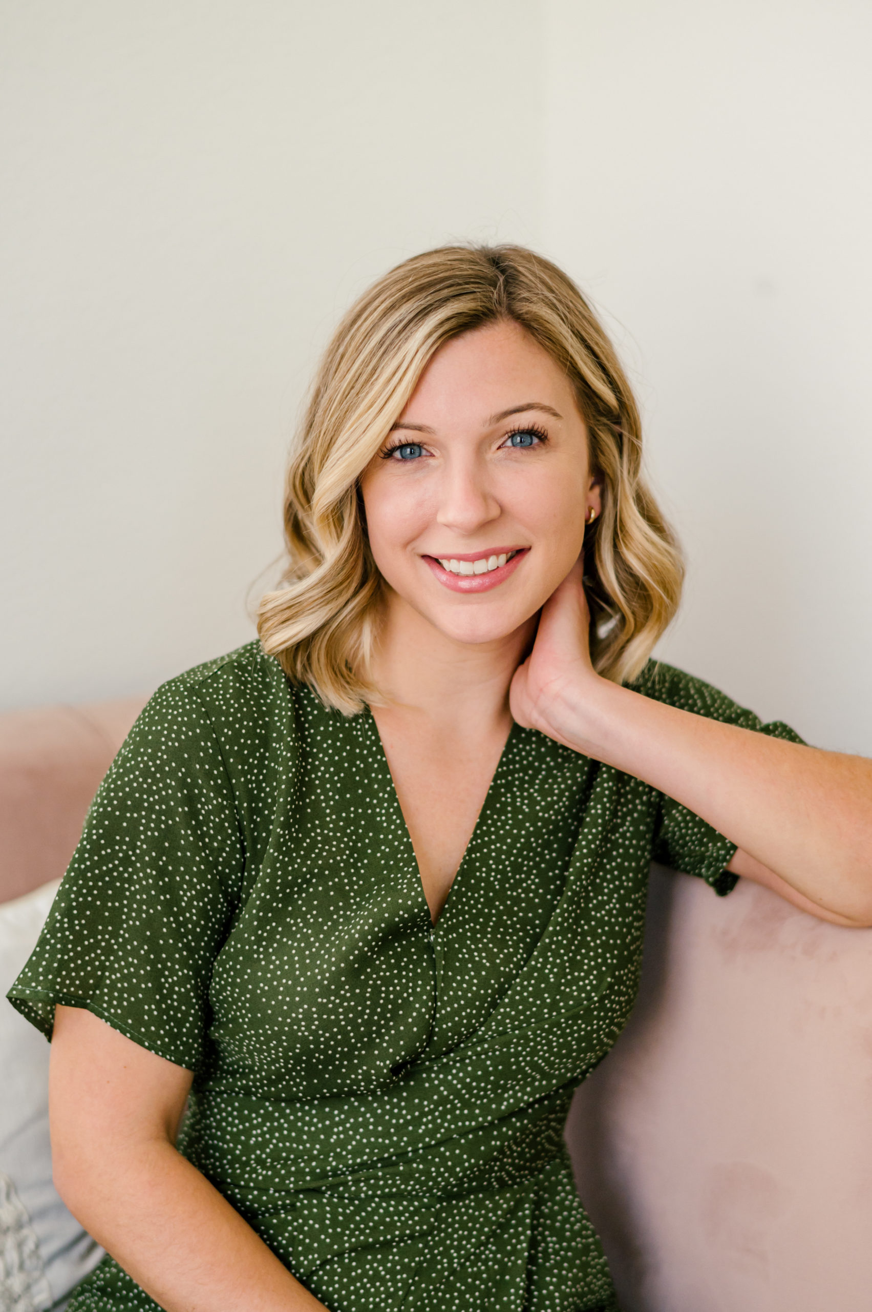 Real estate agent sitting and smiling for her headshot at her branding session