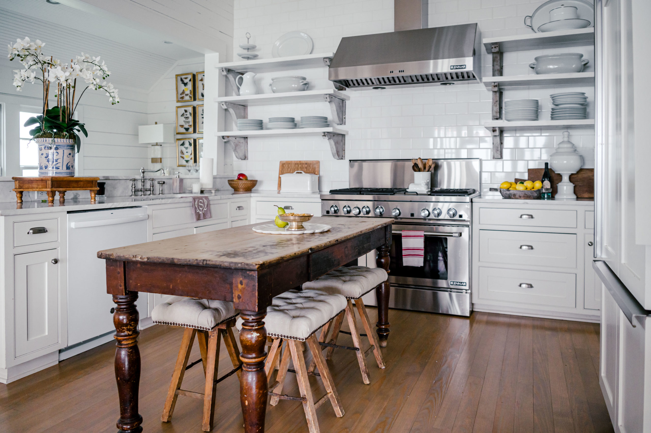 Interior Photography of a beautiful Farm house kitchen with a wooden island and chairs 