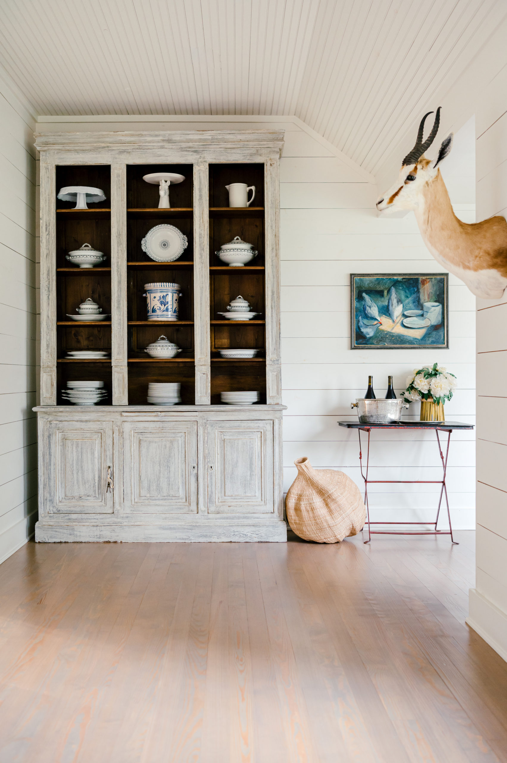 Interior Photography of little corner in the Round Top Farmhouse with a beautiful china cabinet and china on the shelves