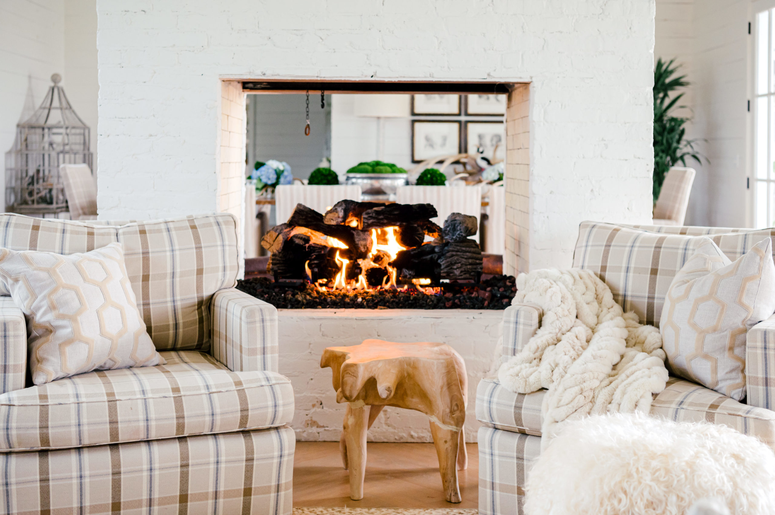 Interior Photography of living room interior furniture with striped love seats with fire pit