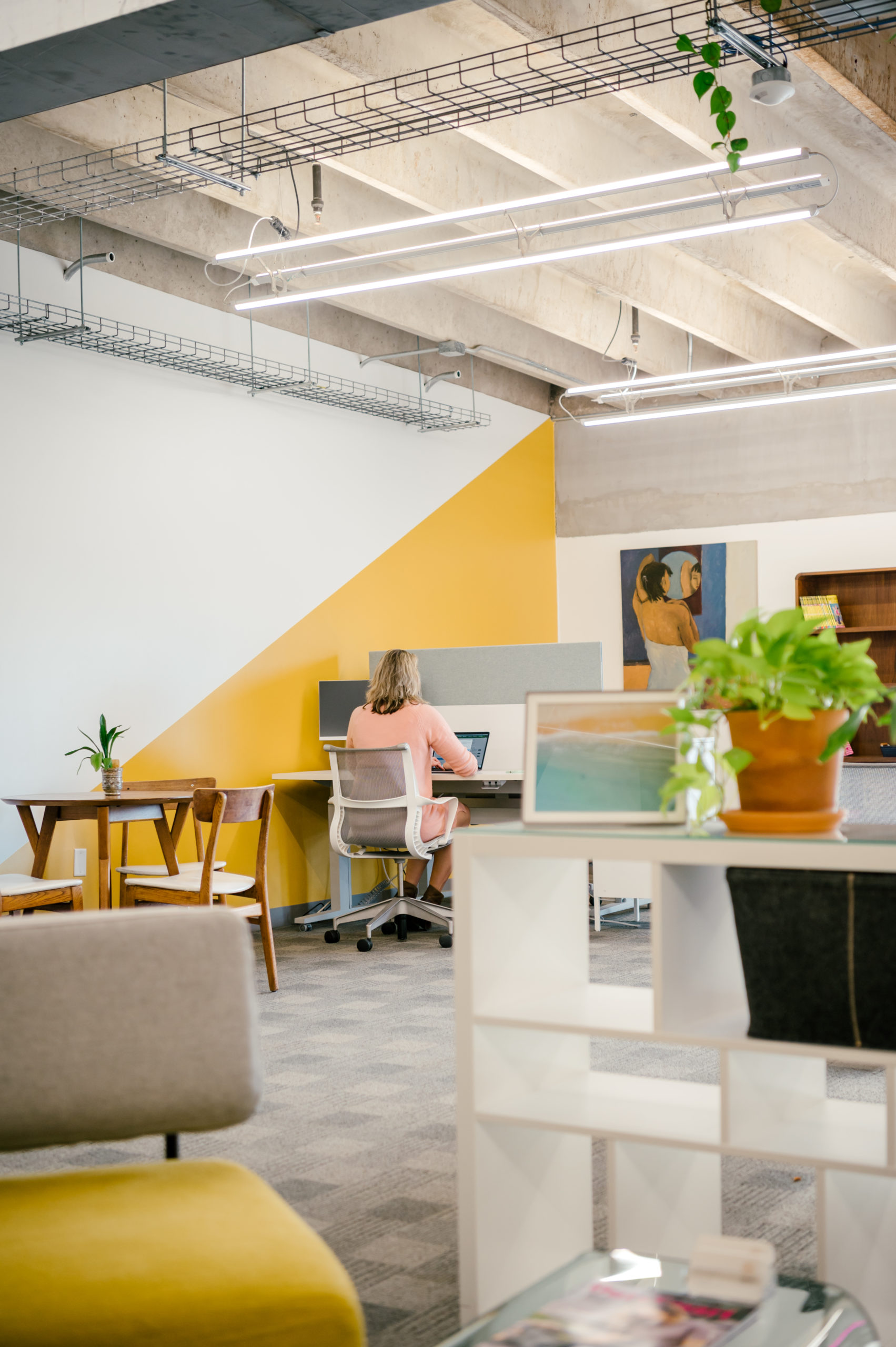 Photo of interior office workspace with lounge chairs and desks