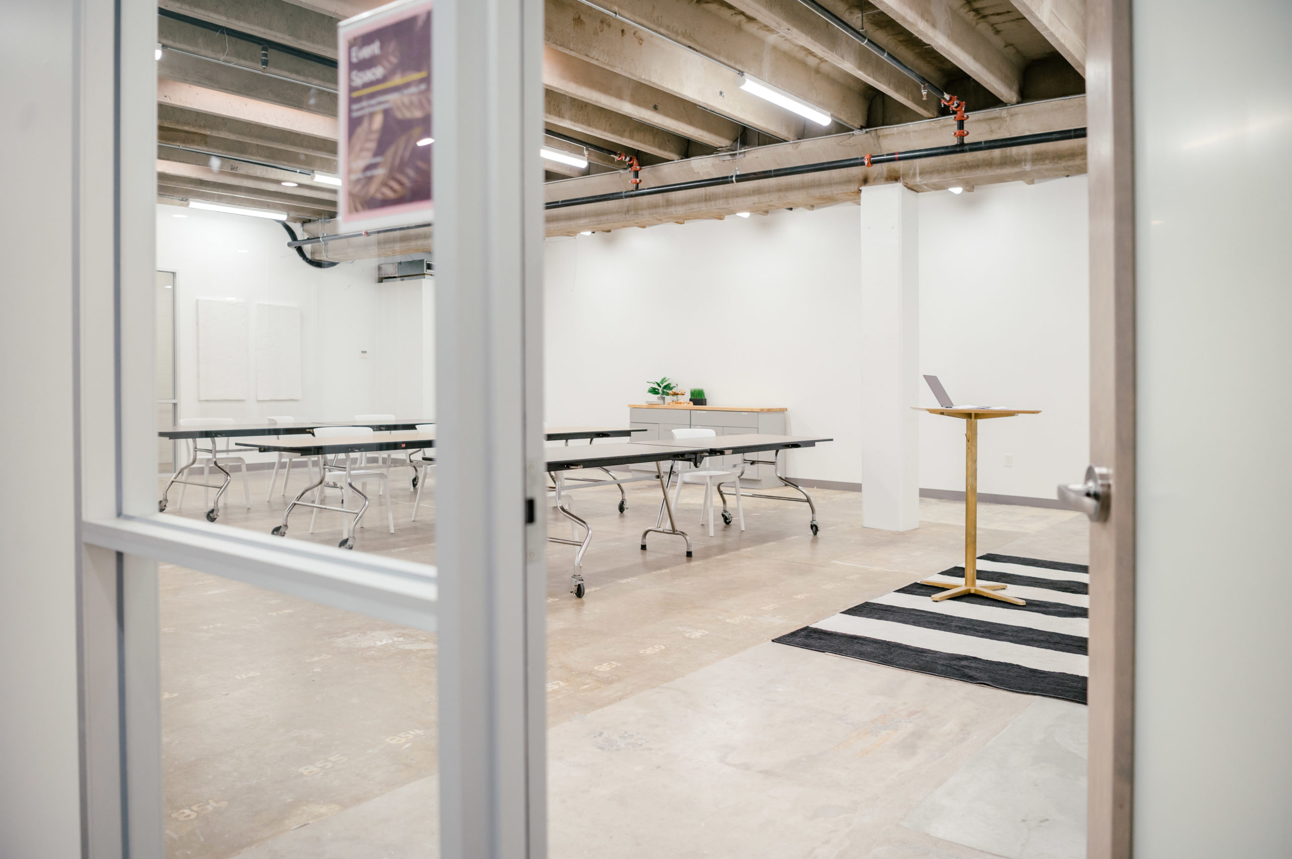 Photo of an empty workspace with long tables and chairs