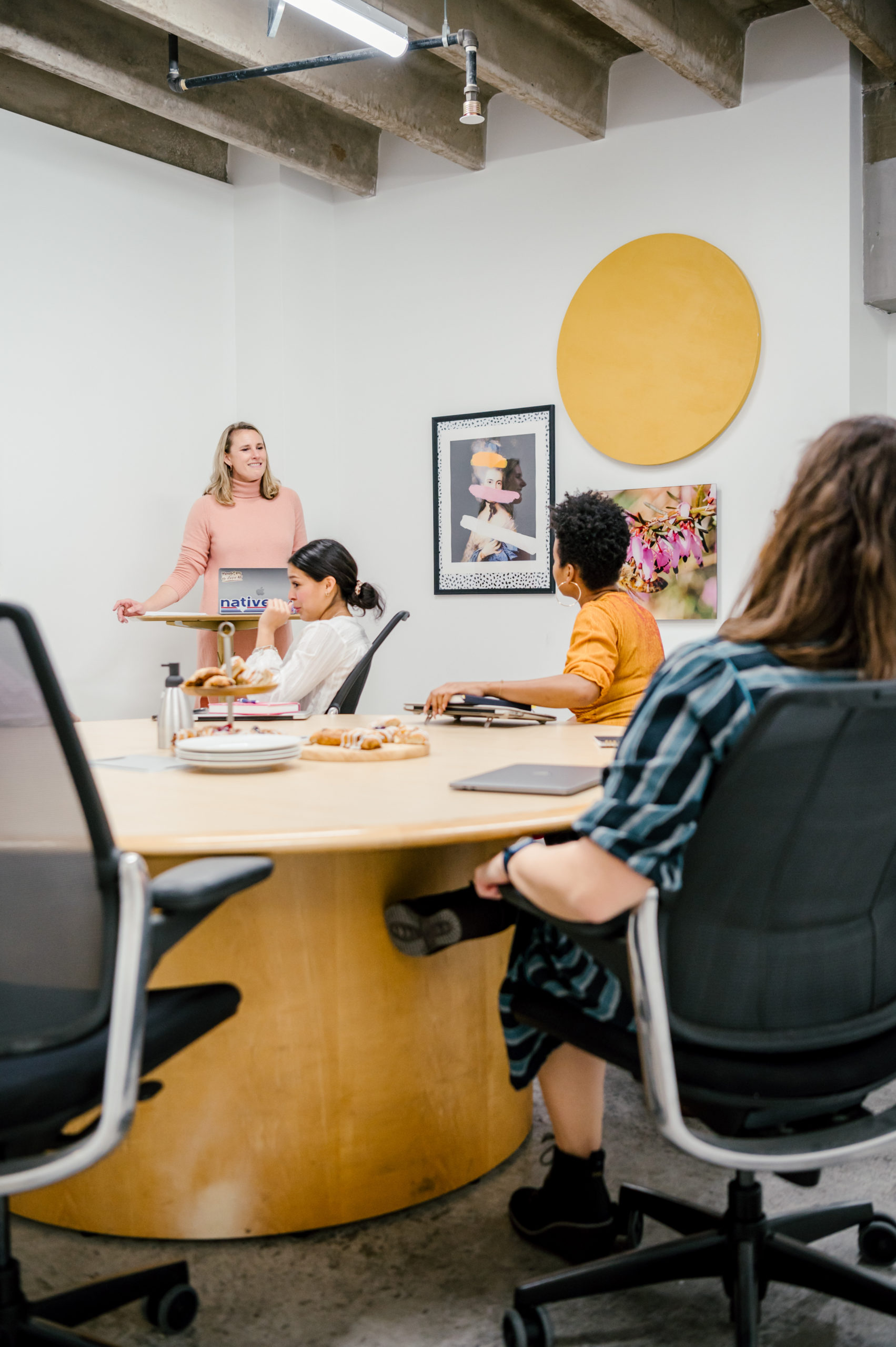 Personal Brand Photography of women in a workspace on a roundtable chatting