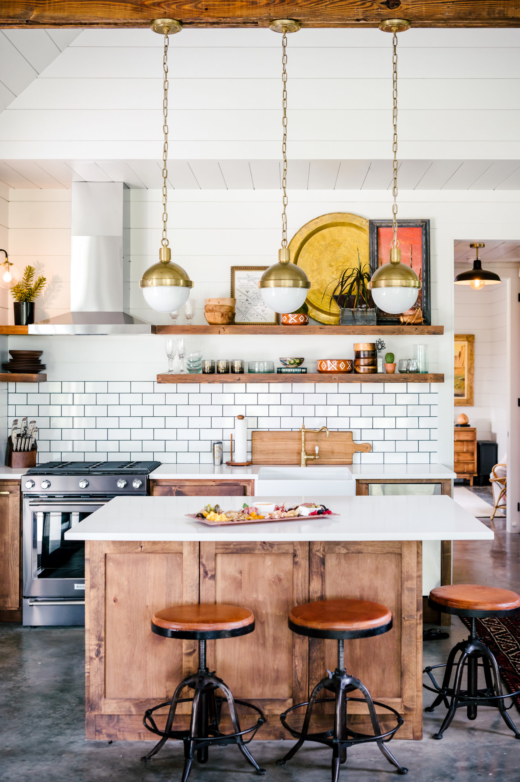 Kitchen interior with a kitchen island and wooden stools