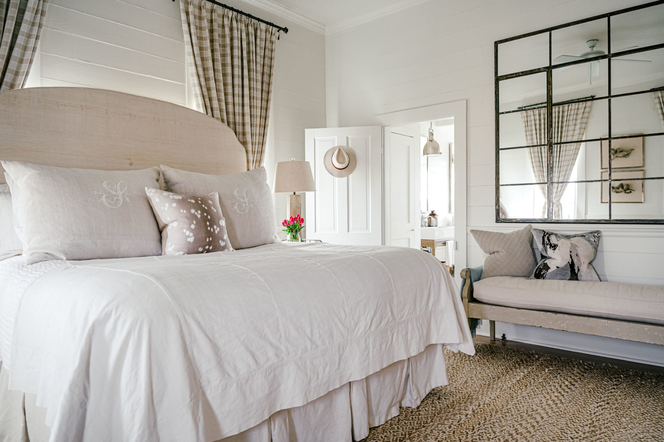 Bedroom interior with a white queen sized bed and pillows