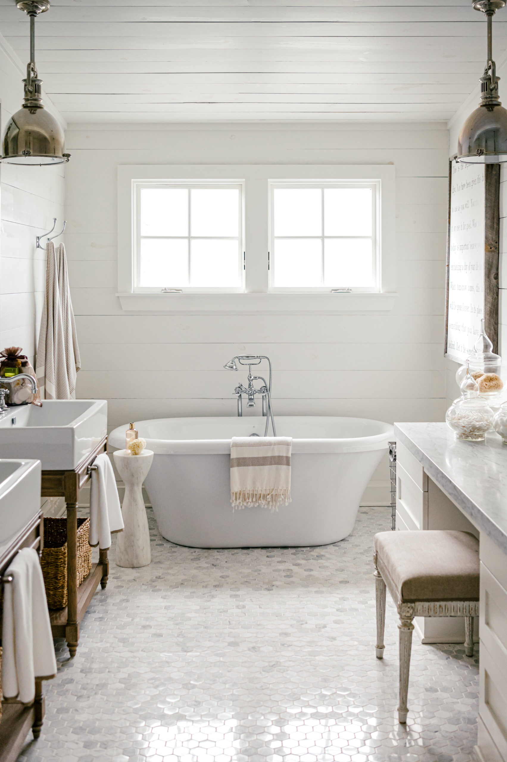 Bathroom interior of a short-term vacation rental with a white bathtub and sinks