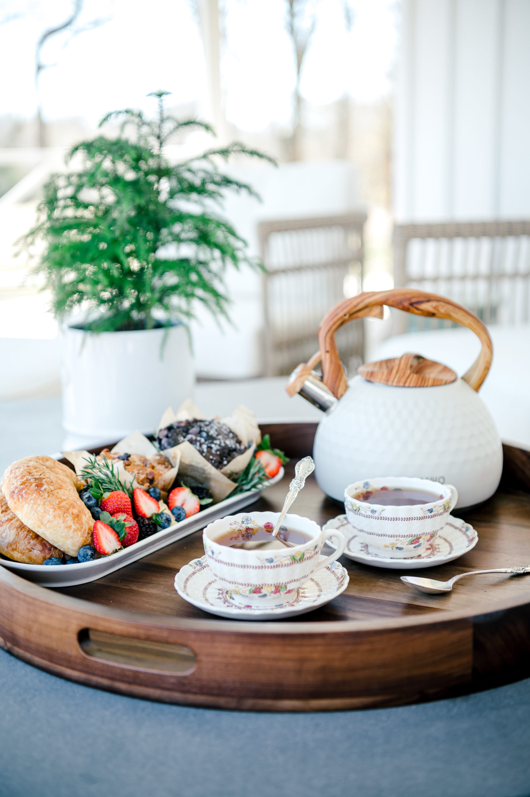 China tea set sitting on a serving tray with breakfast