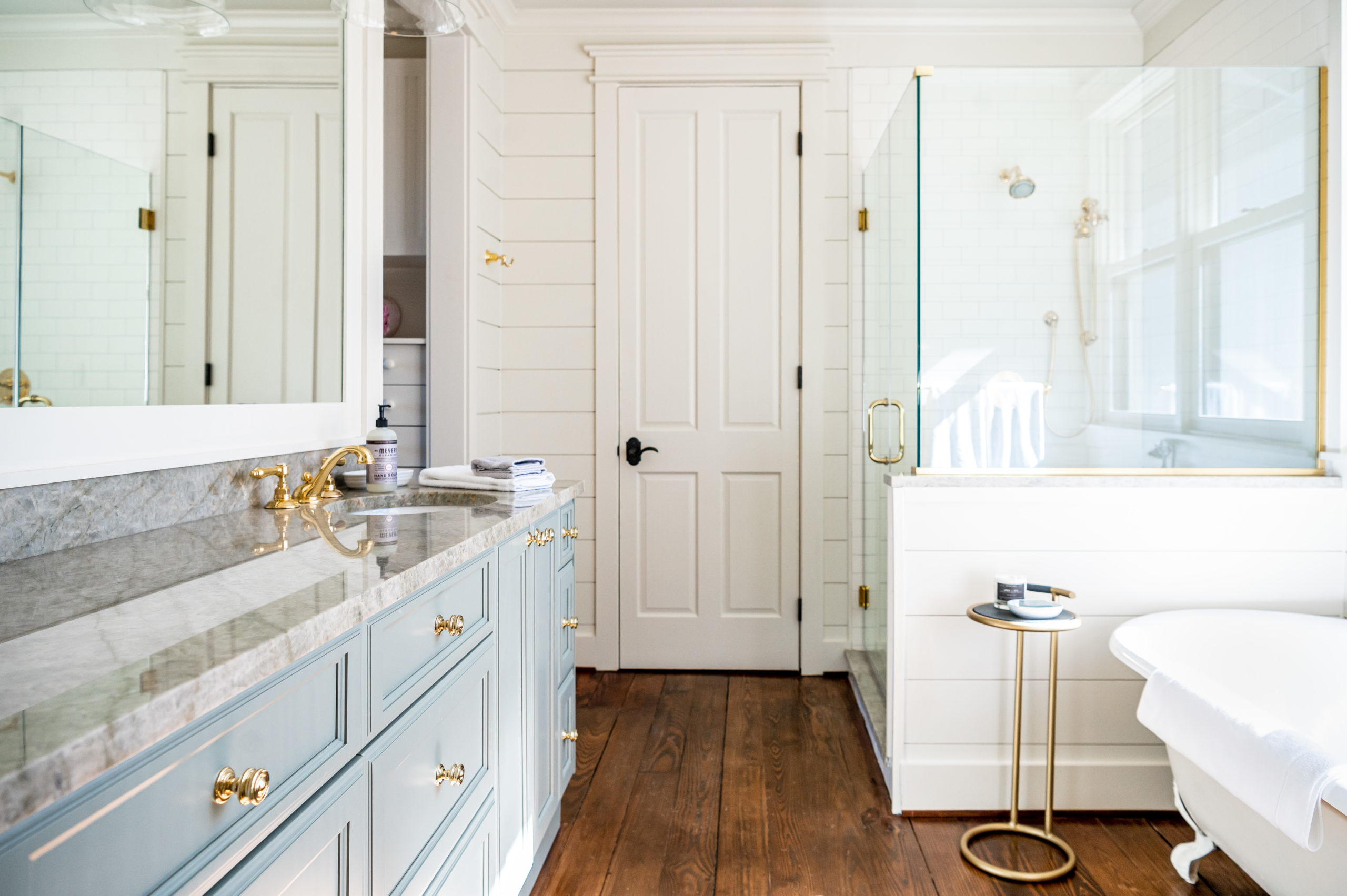 Bathroom interior with a blue and gray granite sink and white bathtub and shower 