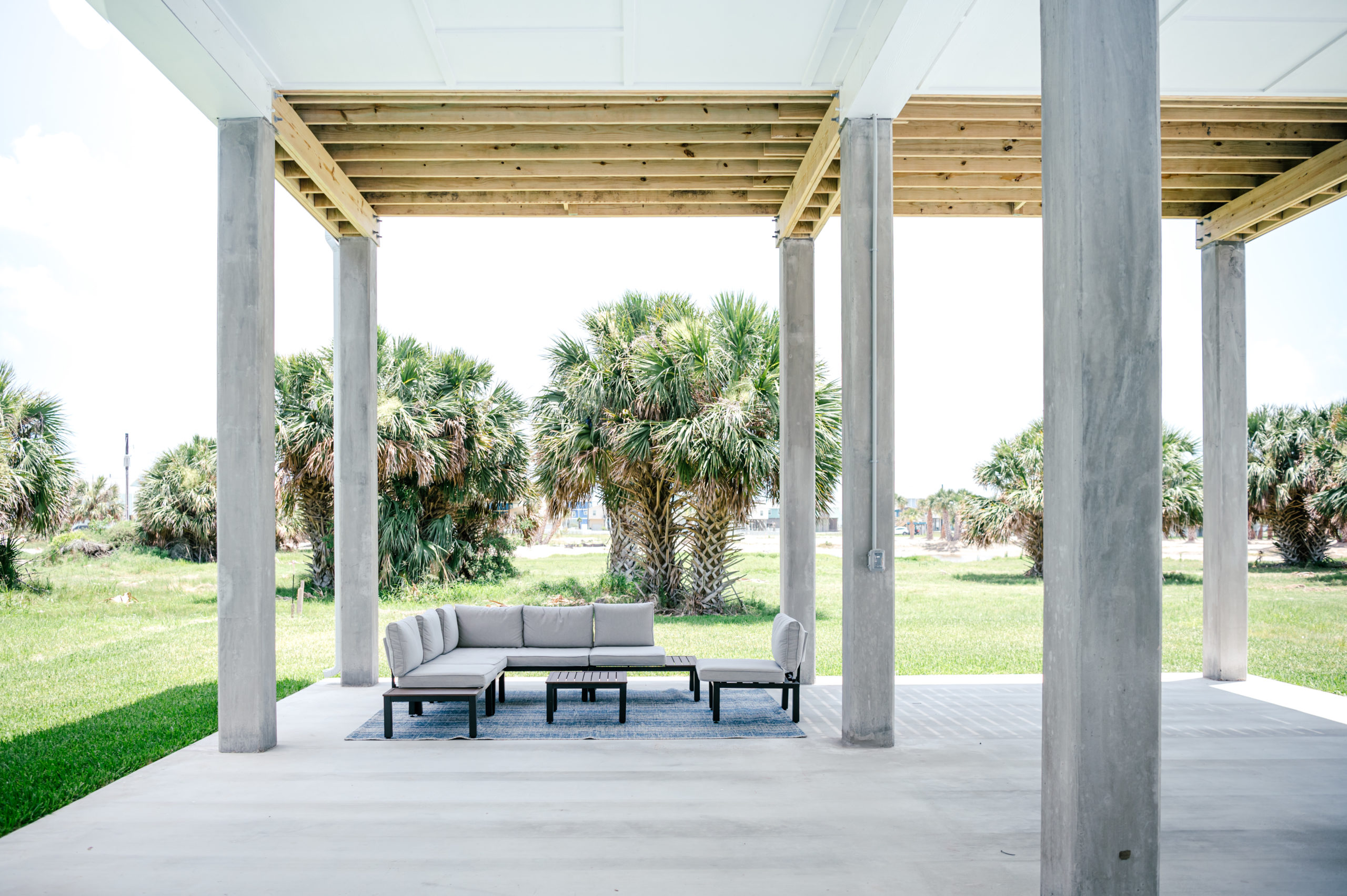 Vacation Rental Photography photos of Grey patio couch outside in a backyard