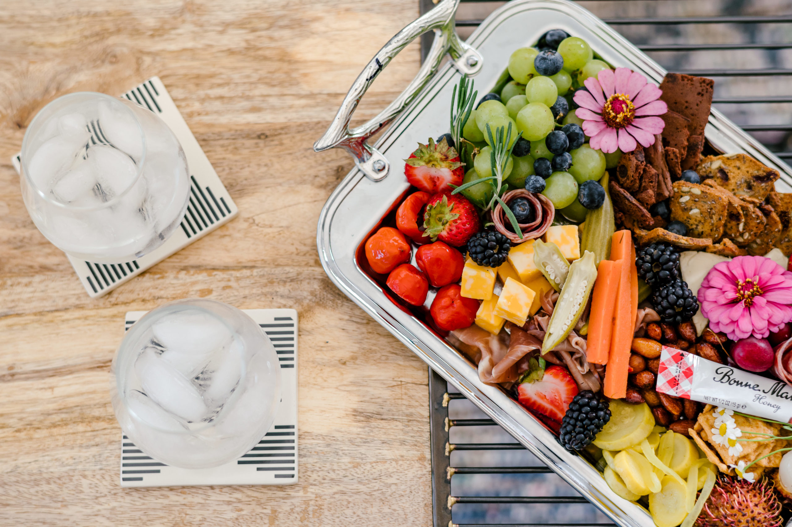 Charcuterie board with two classes of ice water