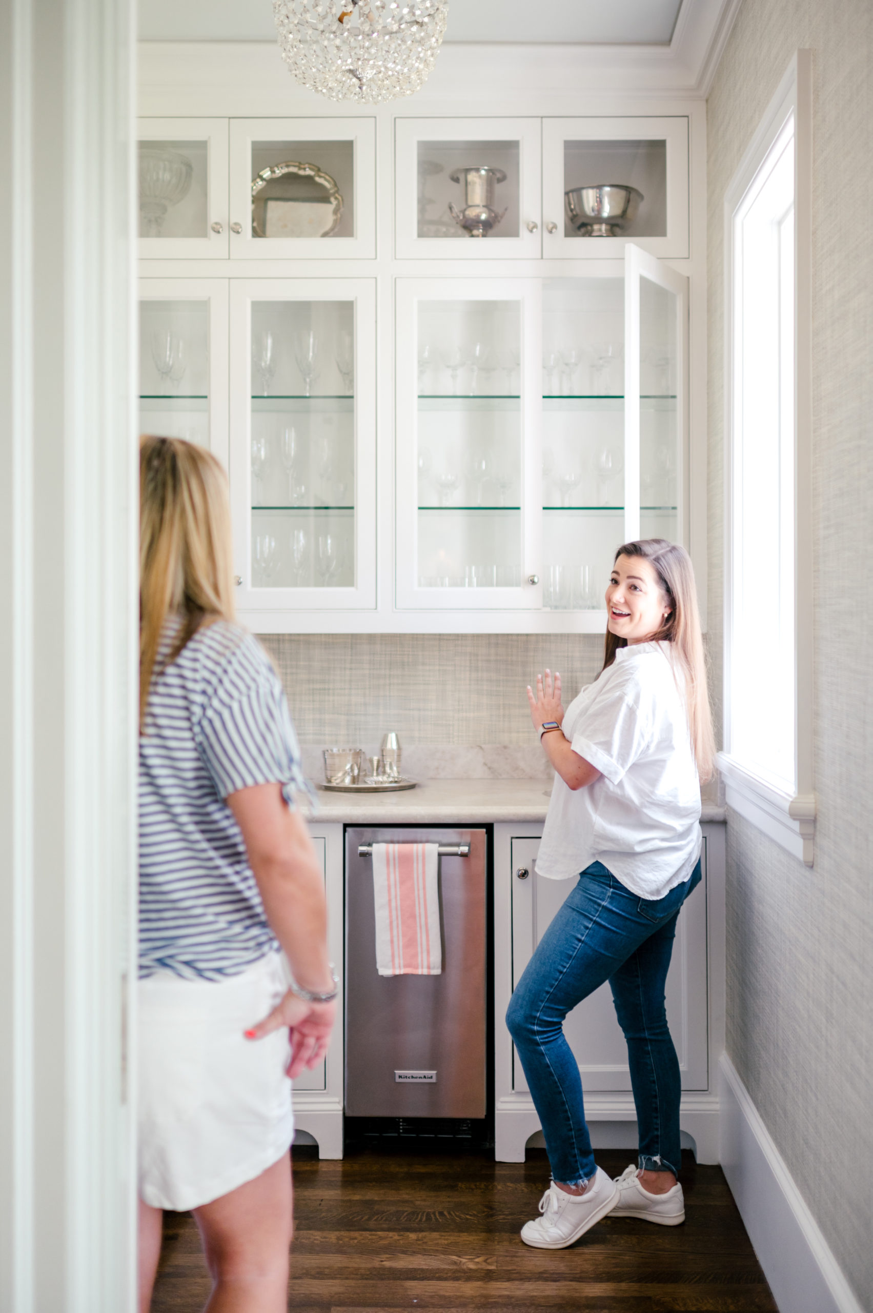 Woman smiling and talking to client in the kitchen 