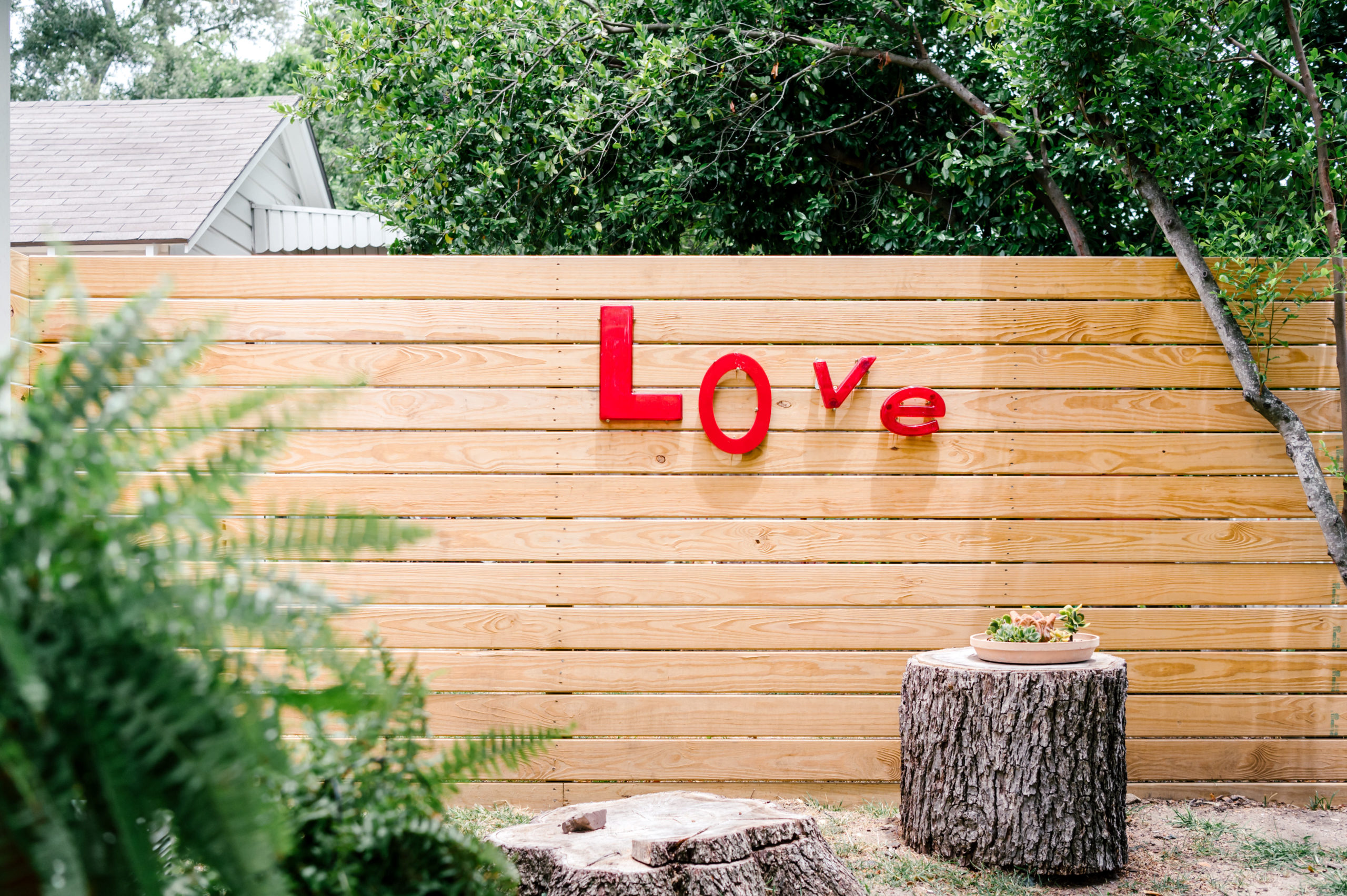 Short-term Rental Photos of outdoor wooden fence with the word love on it 