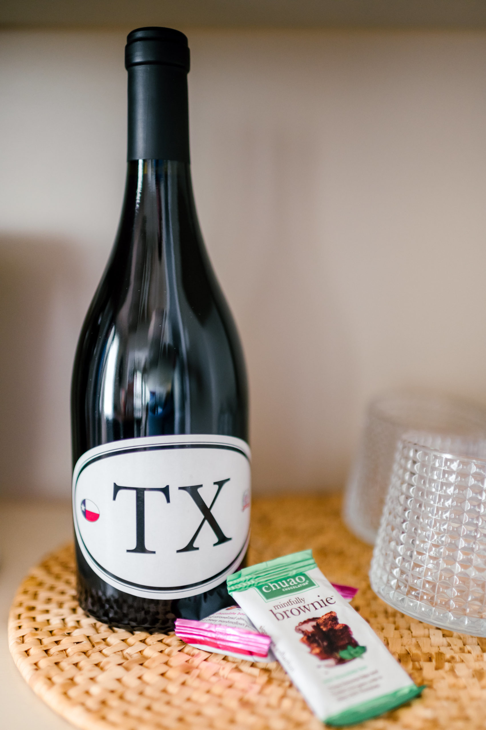 Bottle of wine with the label "TX" on it on a placemat 