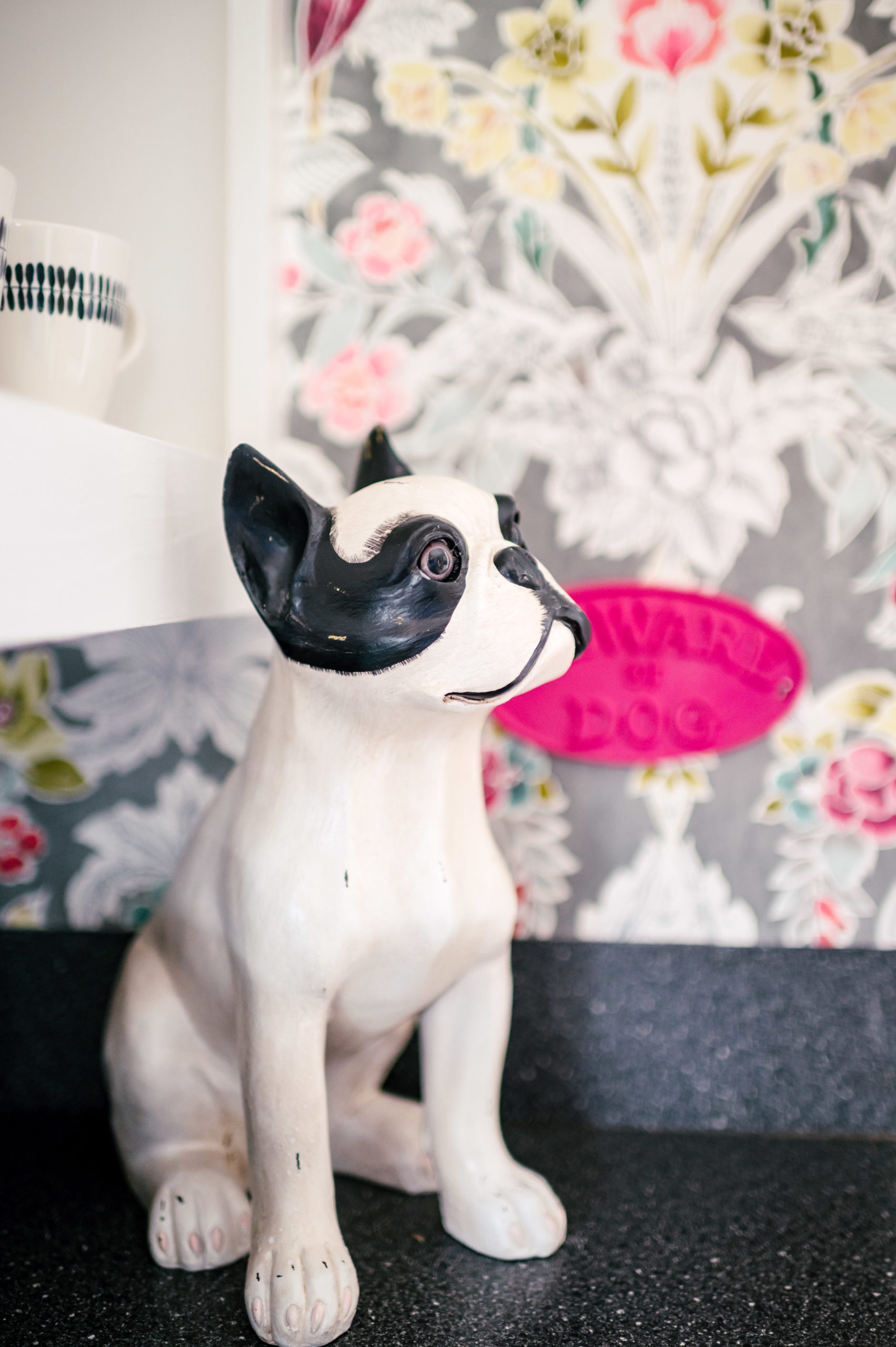 Glass figurine of a black and white puppy sitting on the kitchen counter