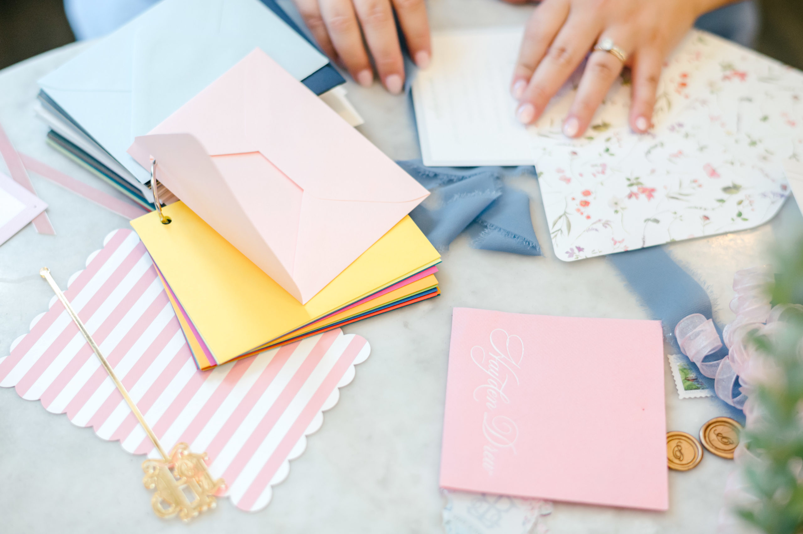 Woman hands putting together paper invitations