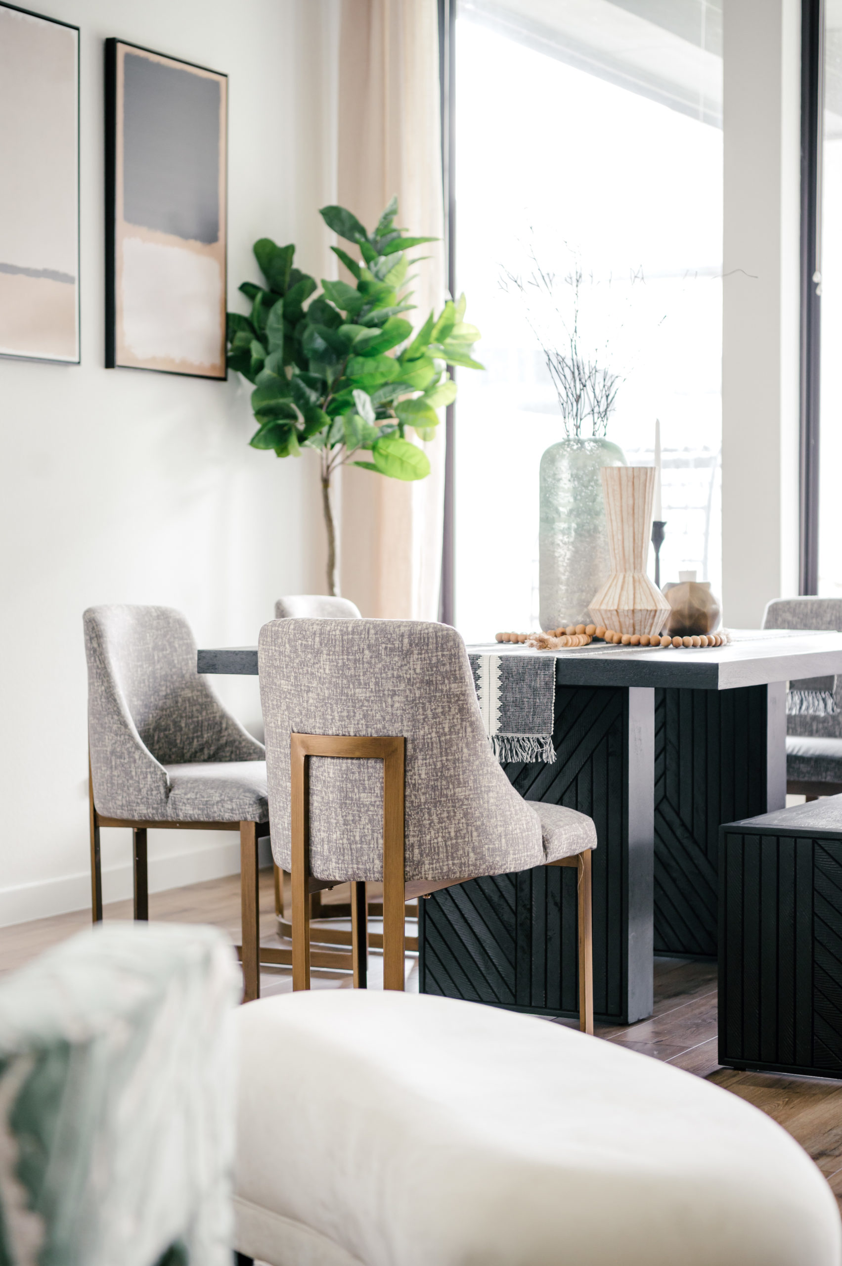 Professional interior photography of dining room with grey seats and a black wooden table