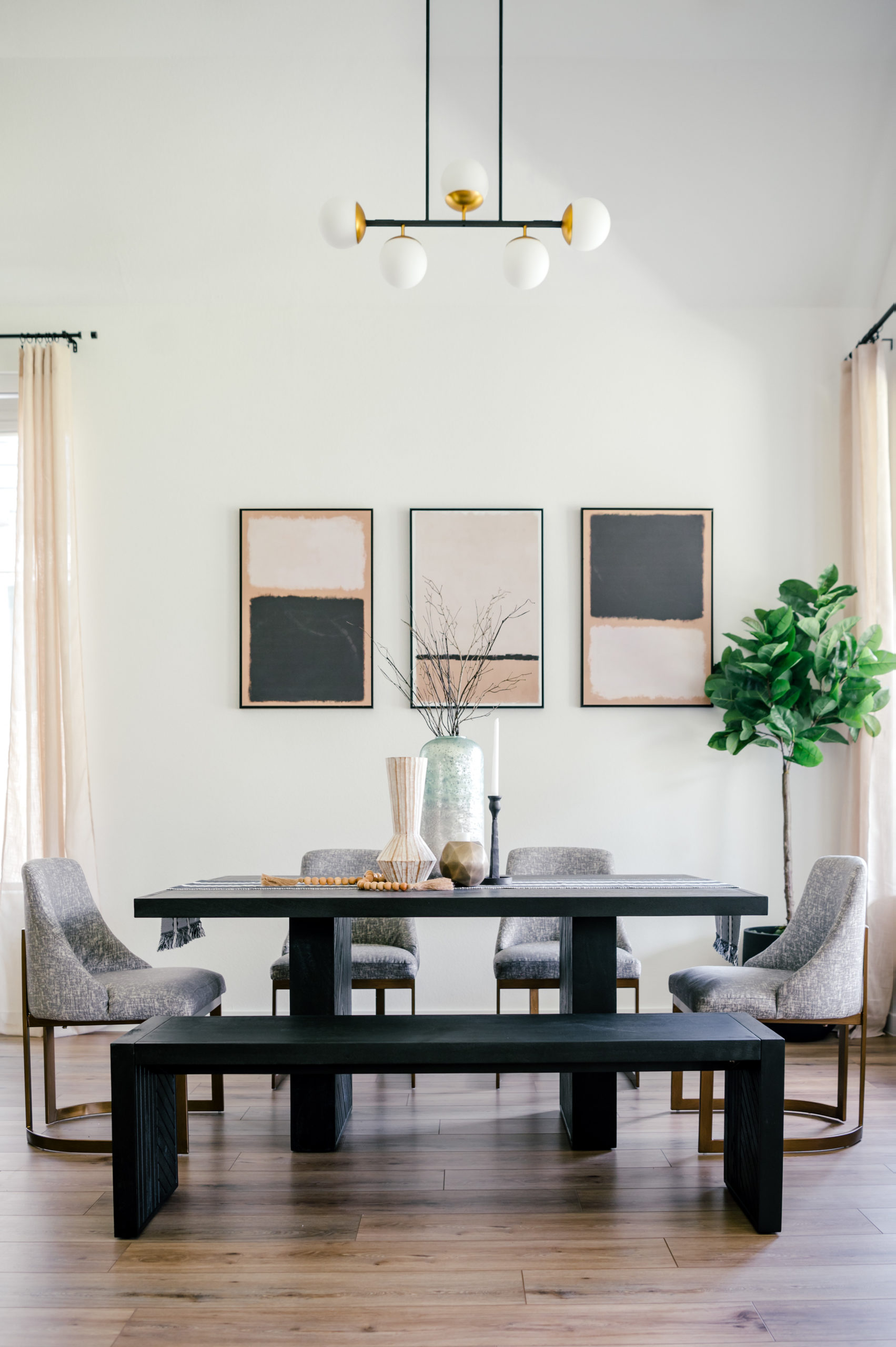 Professional interior photography of dining room with grey seats and a black wooden table
