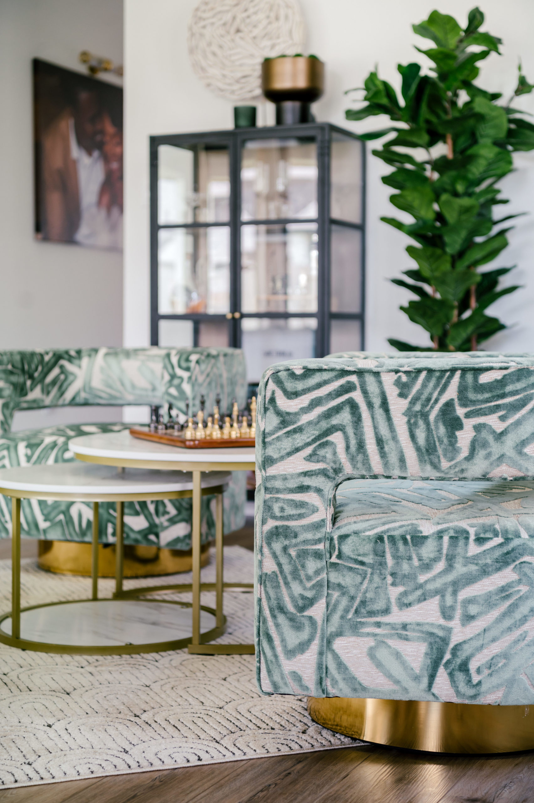 Professional interior photography of living room interior, green love seat and circle table with a chess board