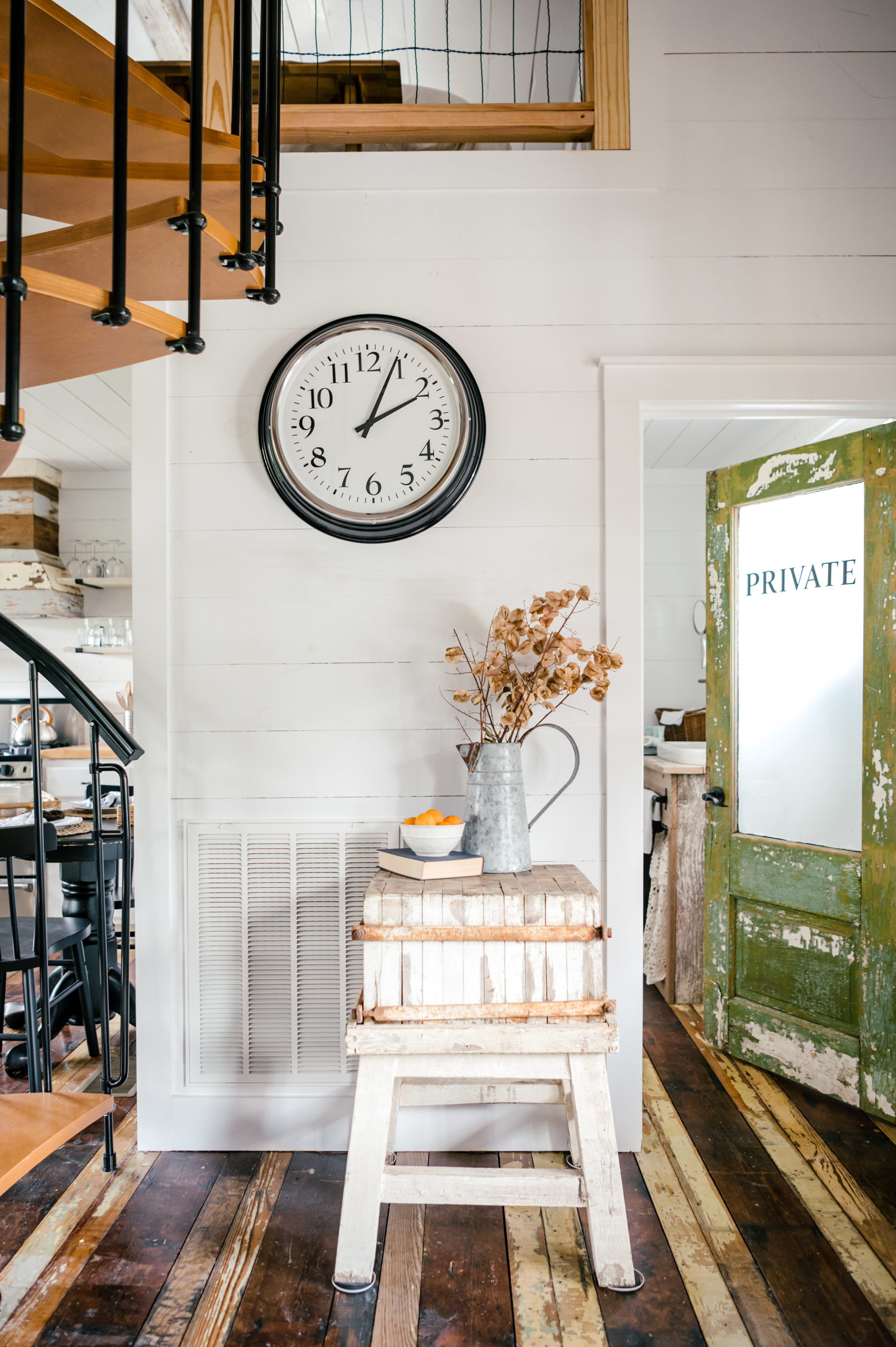 Airbnb photography of rustic wooden side table sitting next to staircase