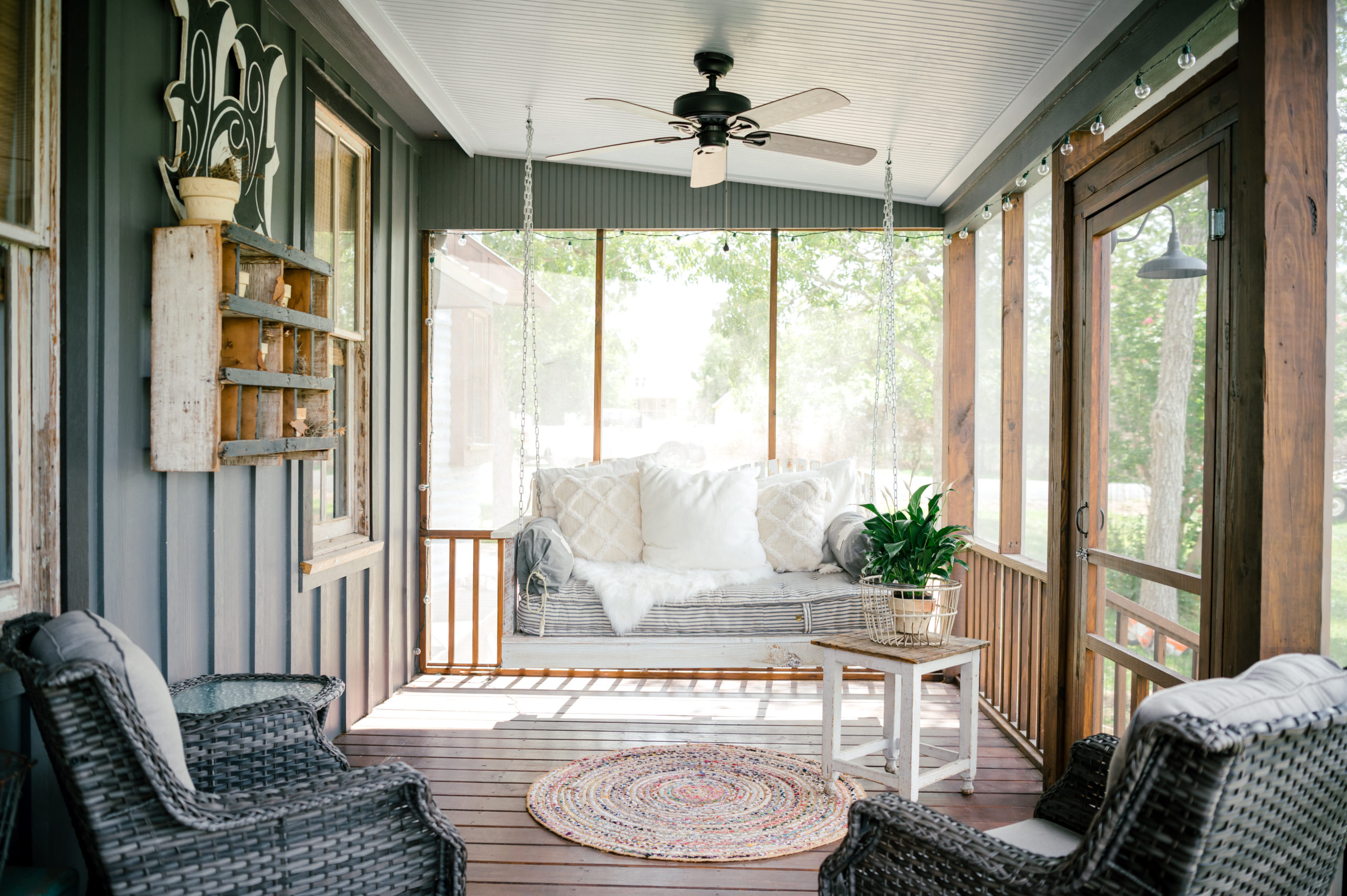 Porch area with porch seating wood flooring, and ceiling fan