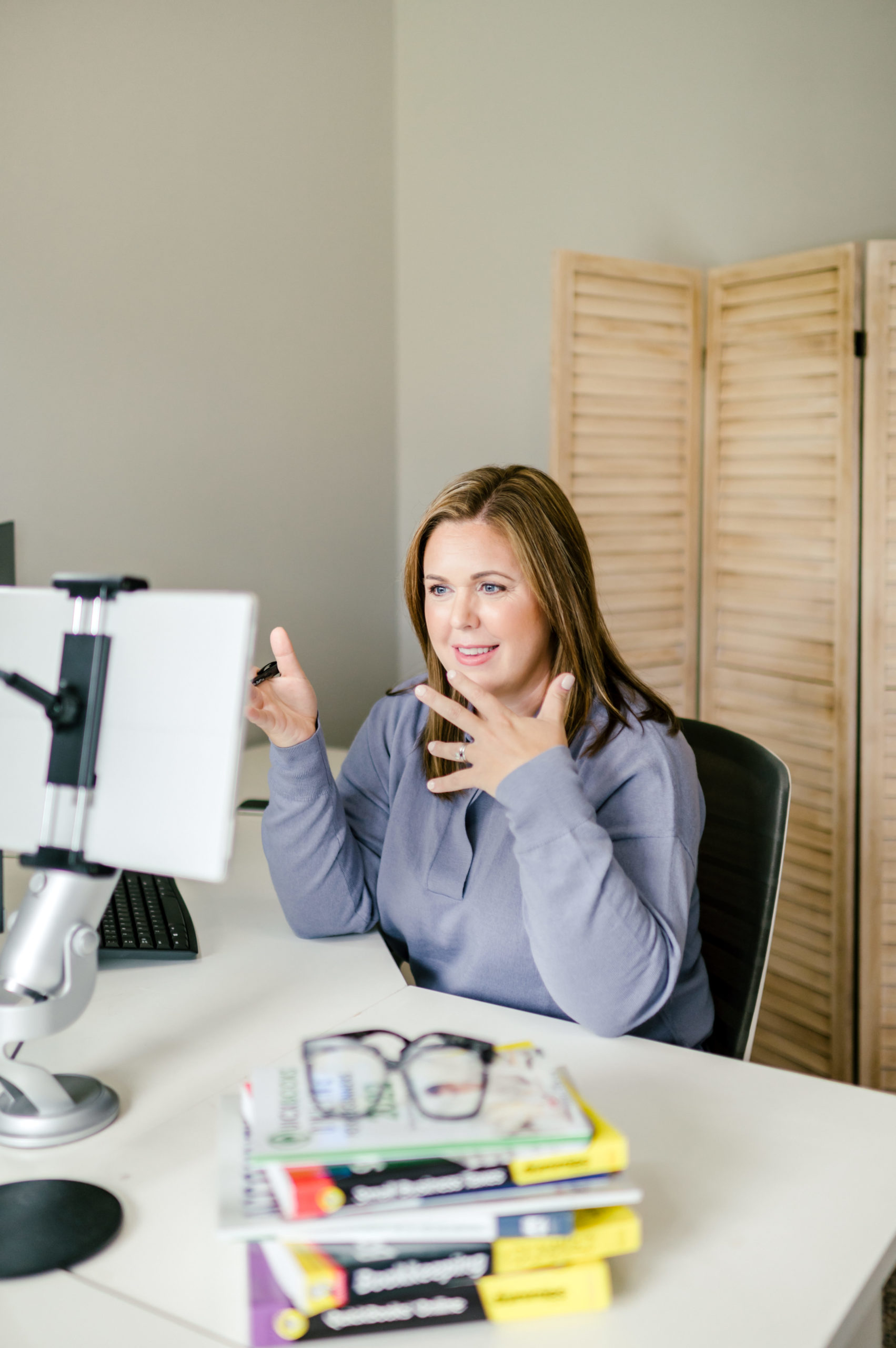 Small Business Branding Photography of CPA business woman at her desk speaking to her computer screen