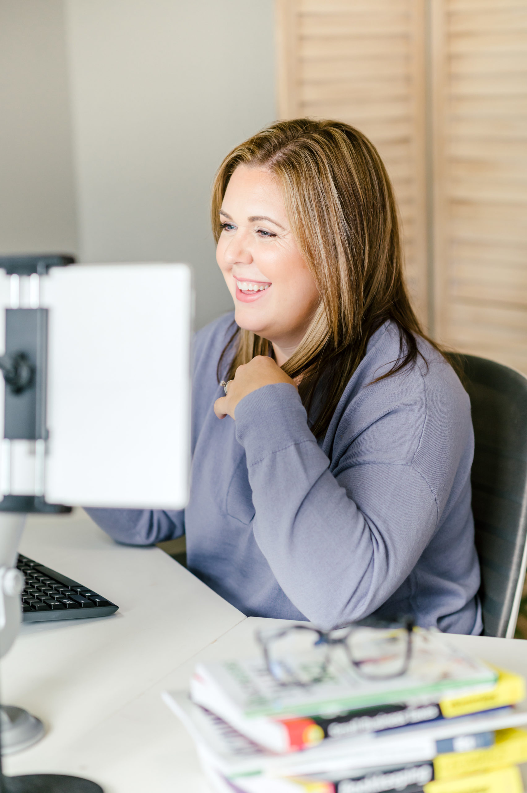 CPA business woman smiling at her computer screen while working 