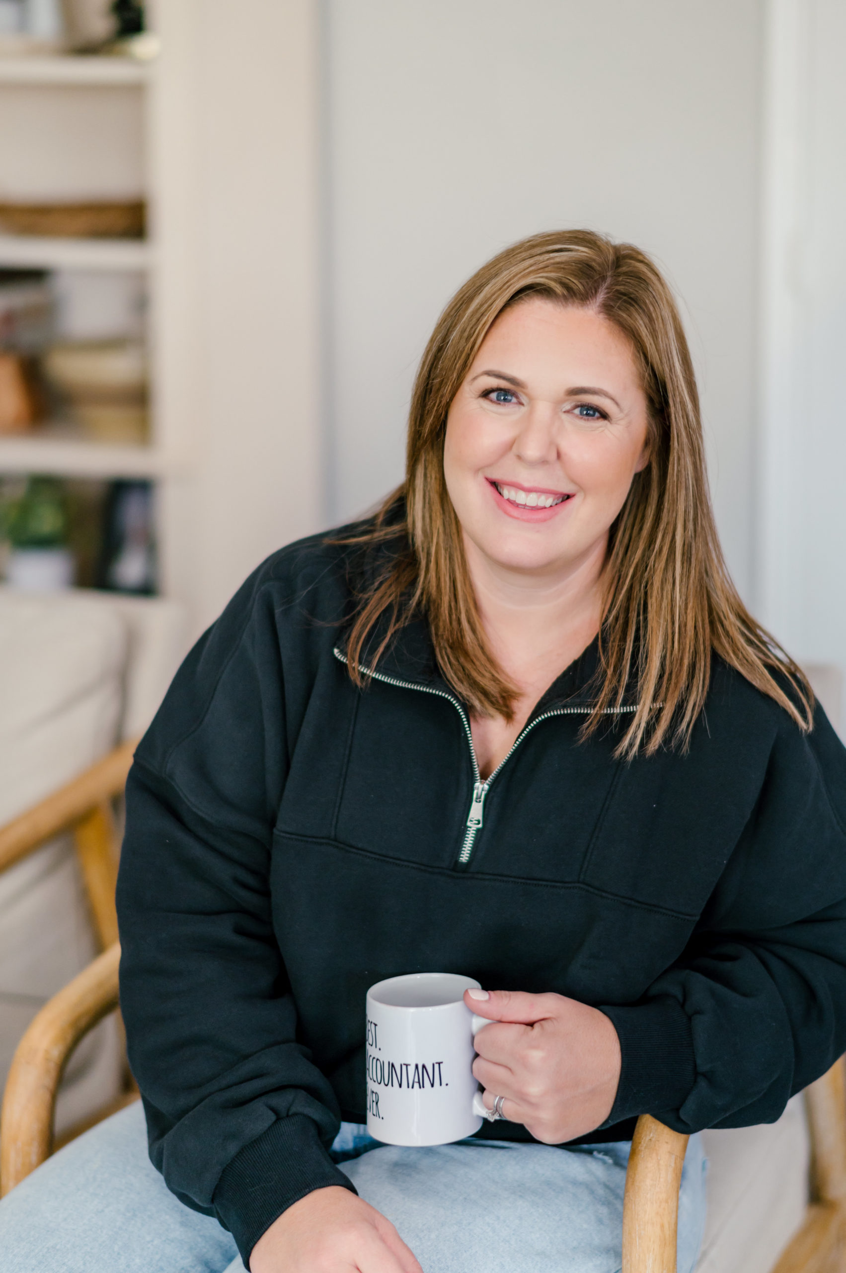 Small Business Branding Photography of a Woman smiling sitting in a wooden chair holding a mug