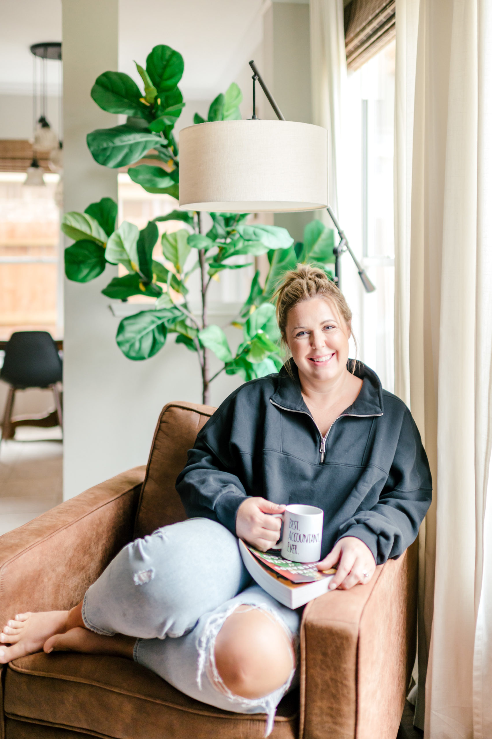 Small Business Branding Photography of a Woman smiling sitting in a brown chair holding a mug