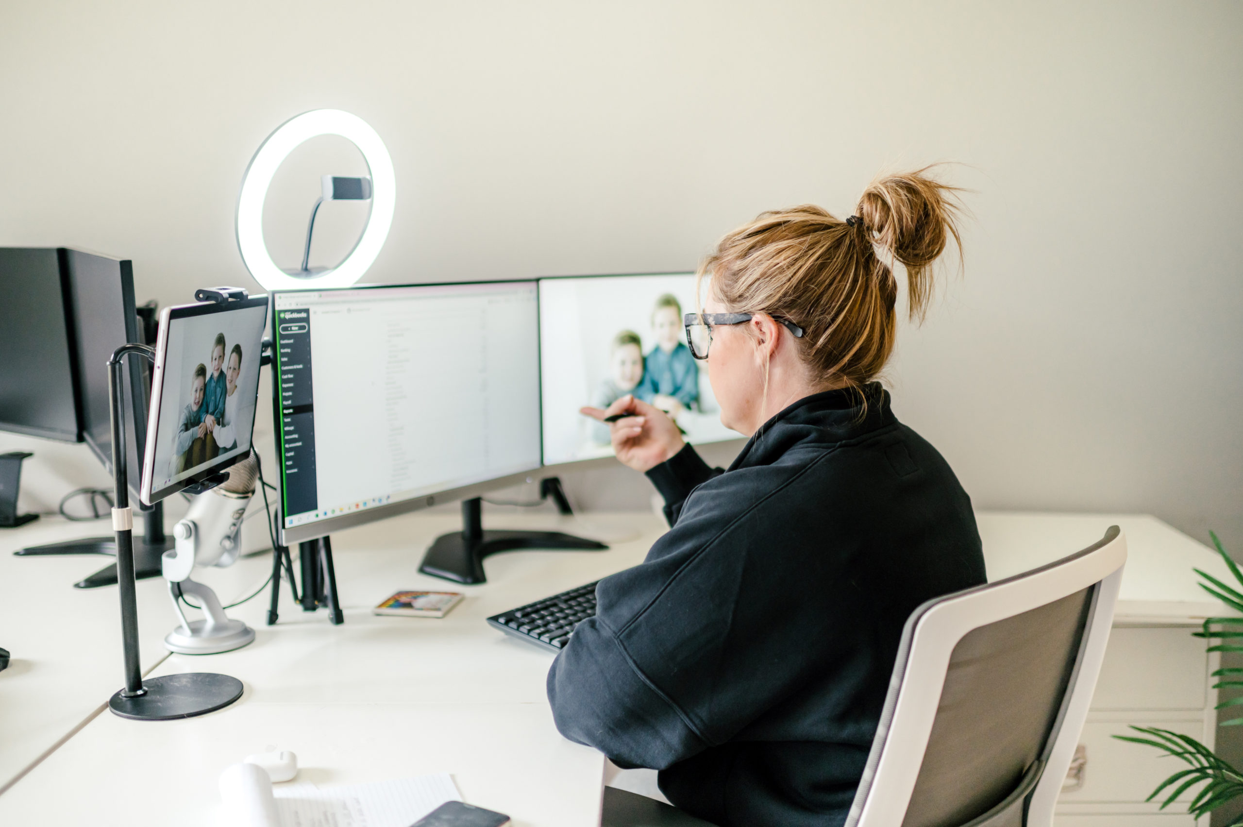 Small Business Branding Photography  of a CPA Business woman pointing at computer screen while talking for a video recording