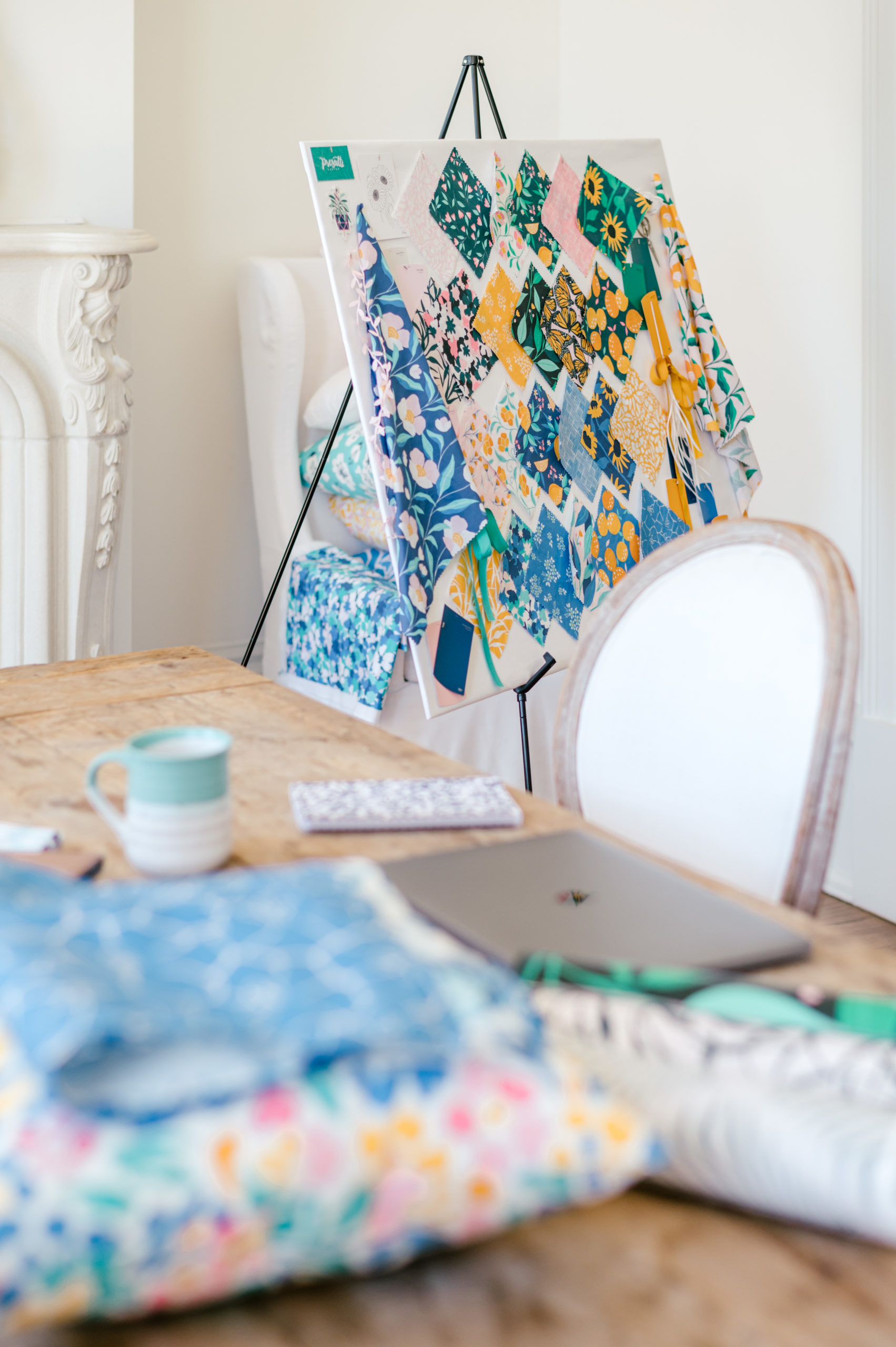 Wooden table with surface pattern designs and fabric and a board full of surface patterns and designs