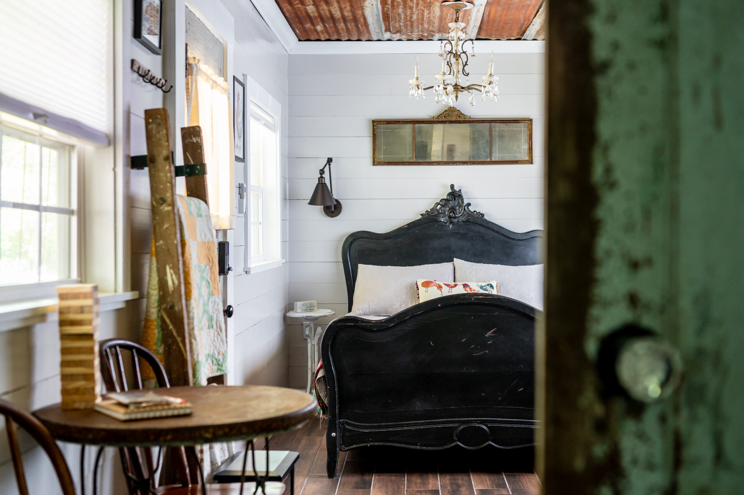 Rustic Bedroom Interior design with black headboard and rustic dining room chairs