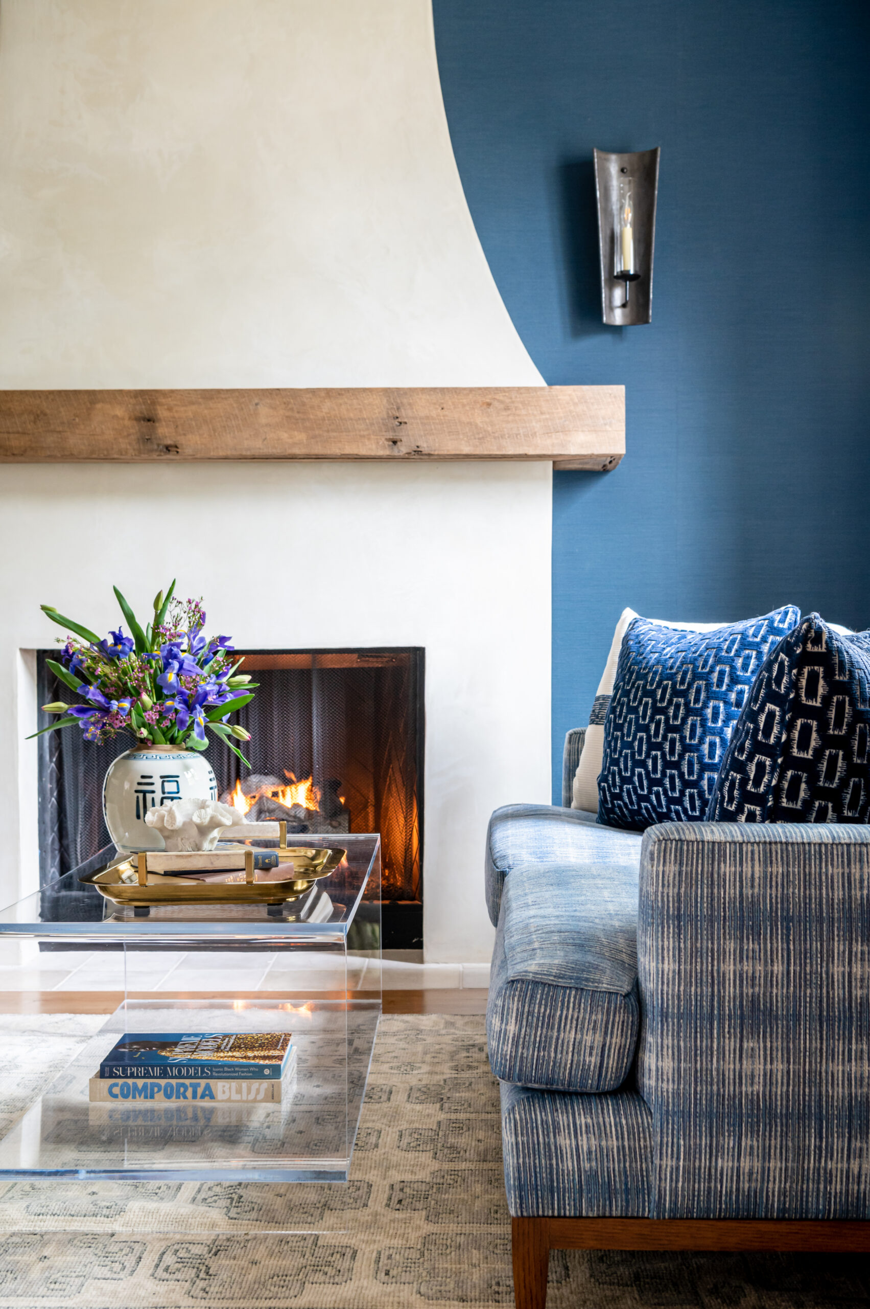 Interior design of living room with blue and colorful details, and a fireplace