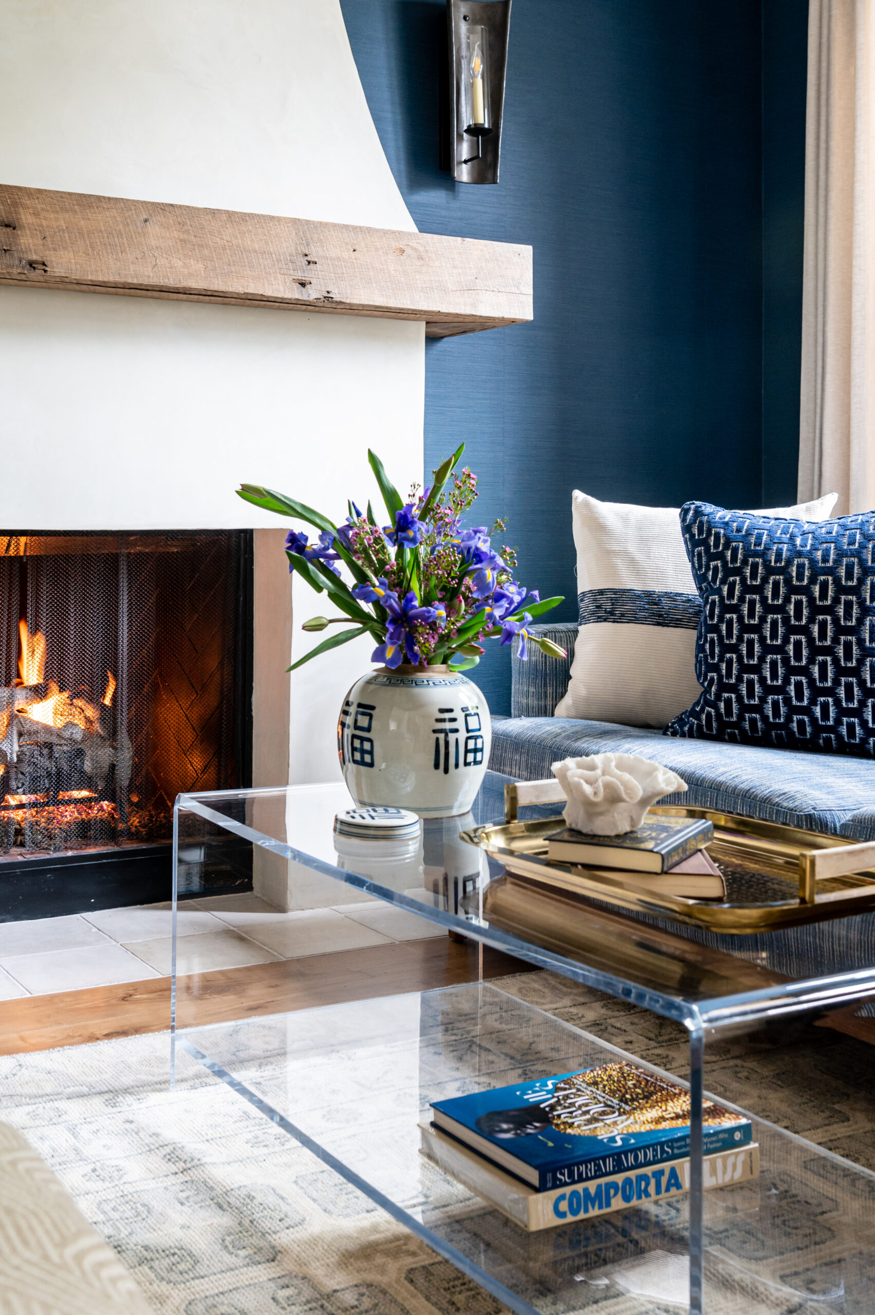 Interior design of living room with blue and colorful details, and a fireplace