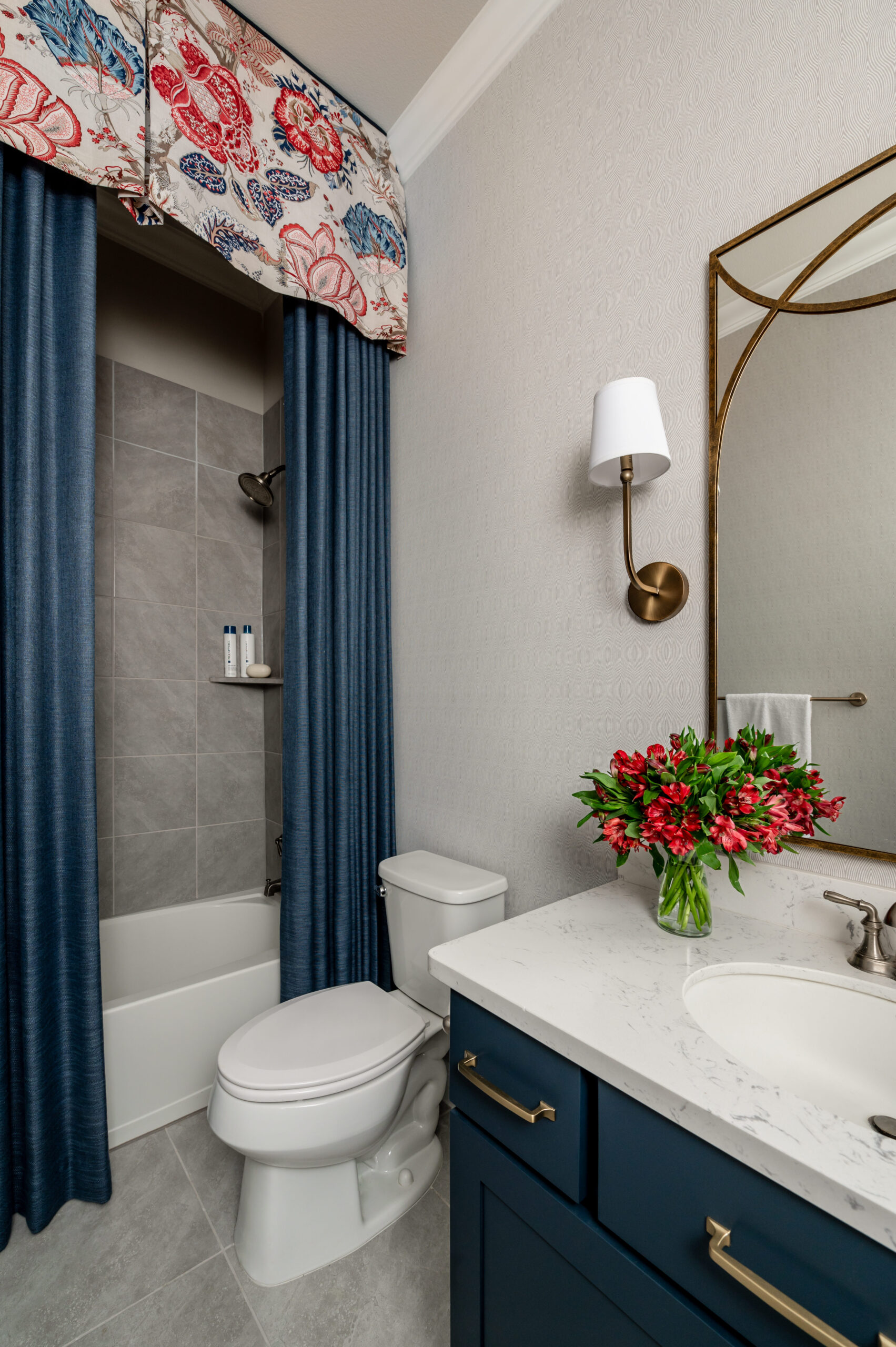 Stunning bathroom interior design with marble counters and blue cabinets