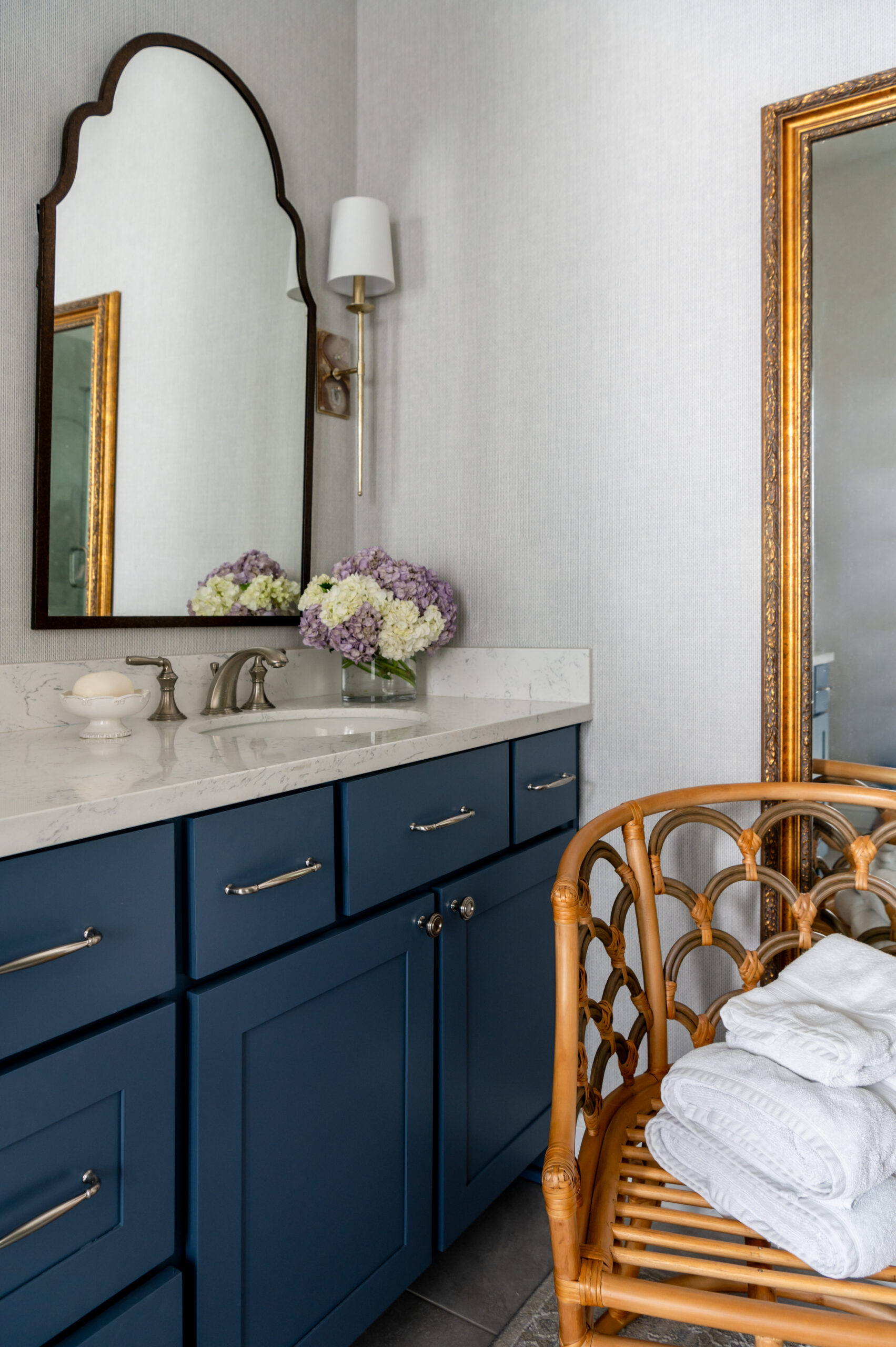 Gorgeous bathroom interior design with blue cabinets and marble counters