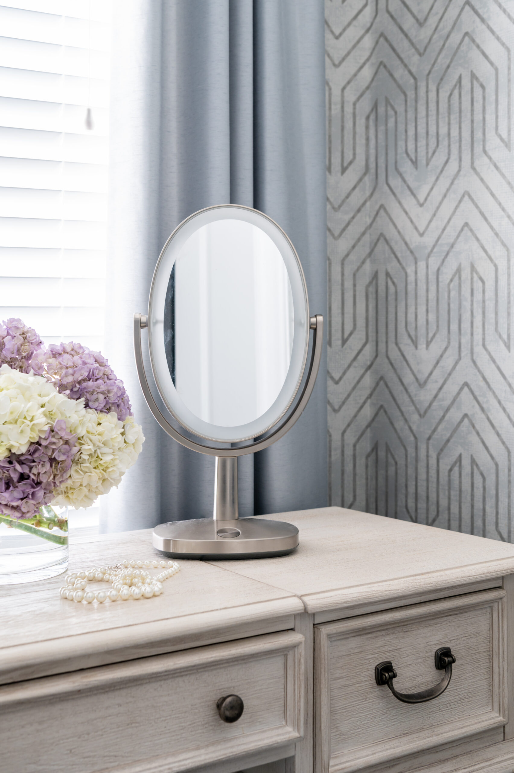 Wood dresser with flowers and mirror