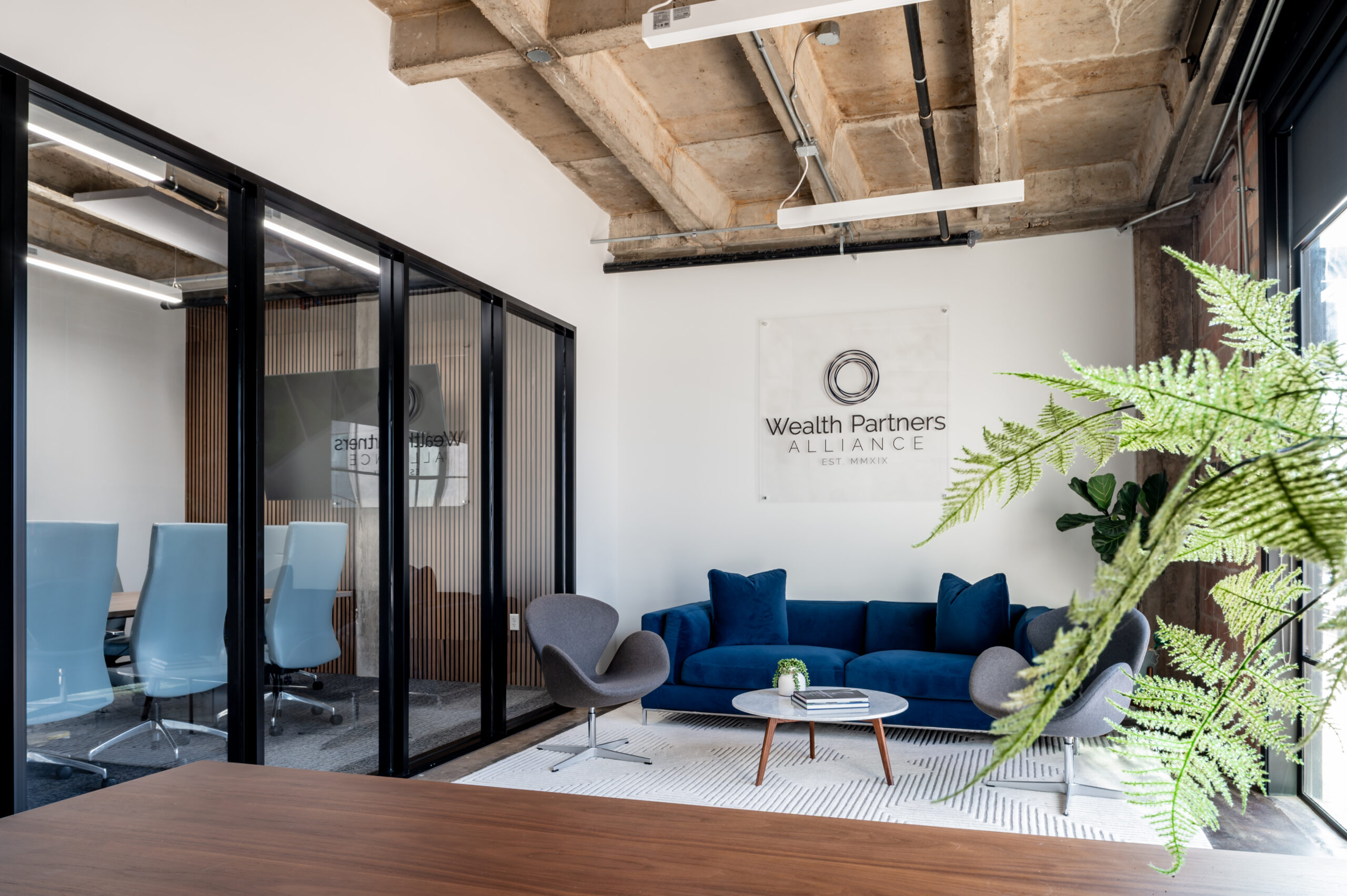 Office space with blue couch and brick walls