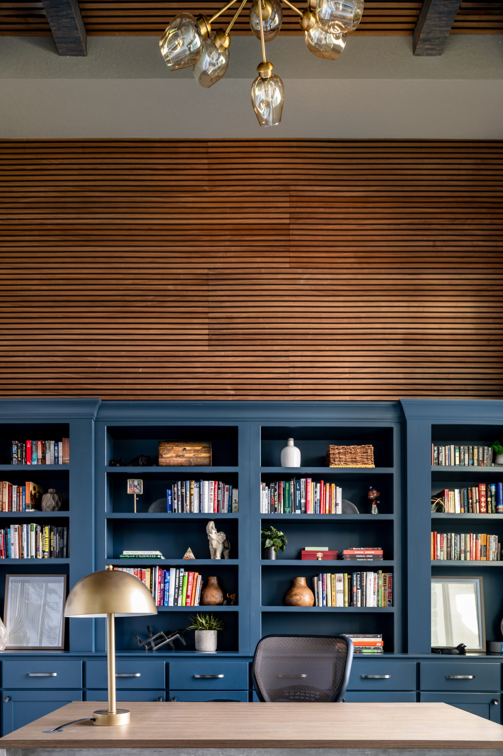 Office interior design with blue book shelf and styled shelving