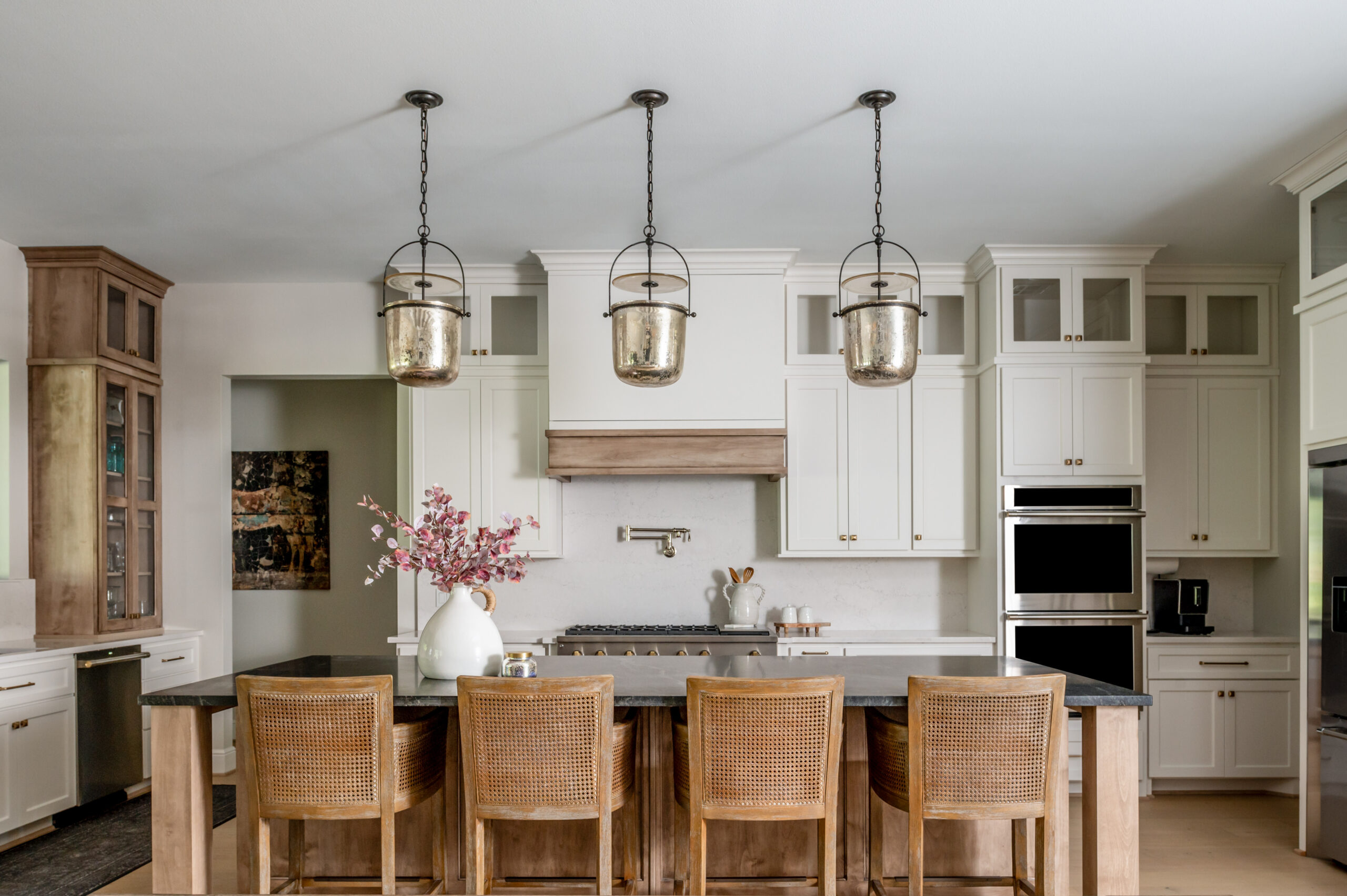 Kitchen interior design with black marble counters and rattan chairs