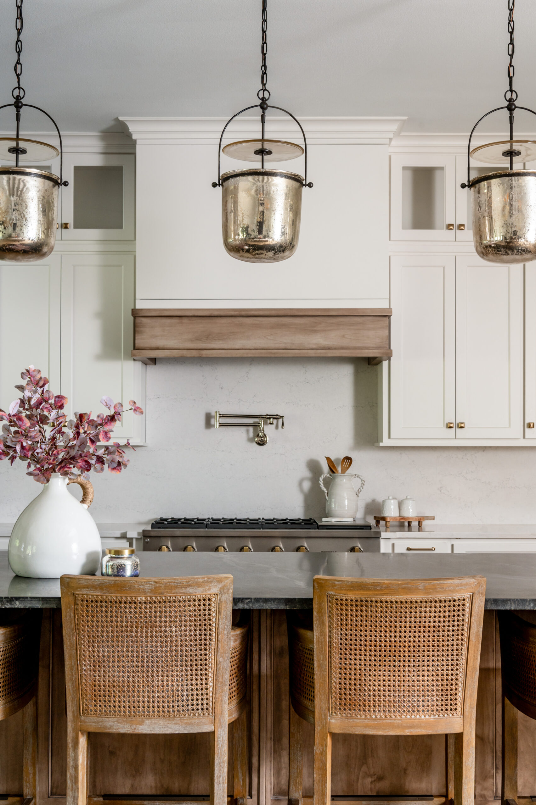 Kitchen interior design with black marble counters and rattan chairs