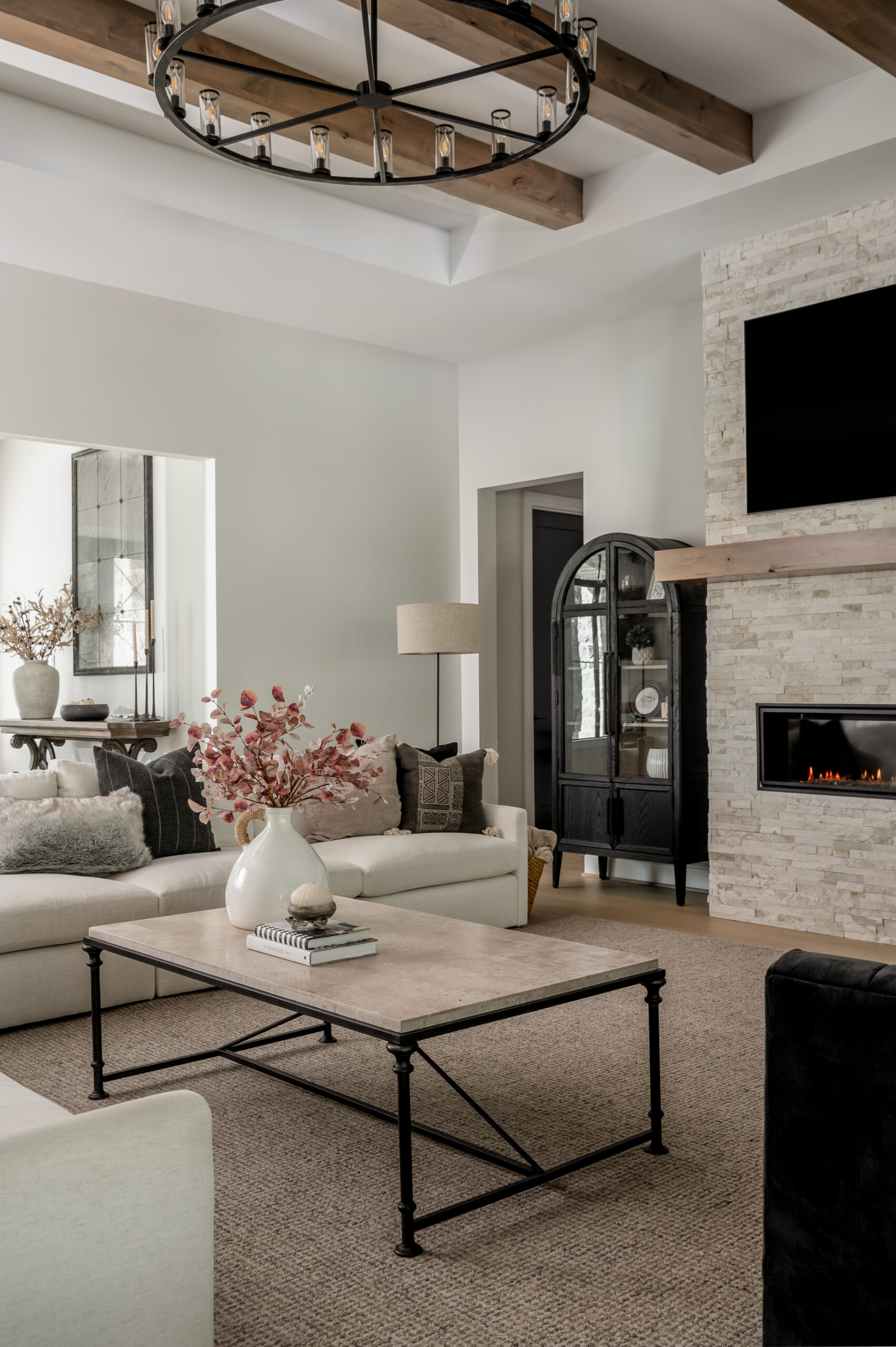 Living room interior design with brick fireplace and neutral furniture and decor
