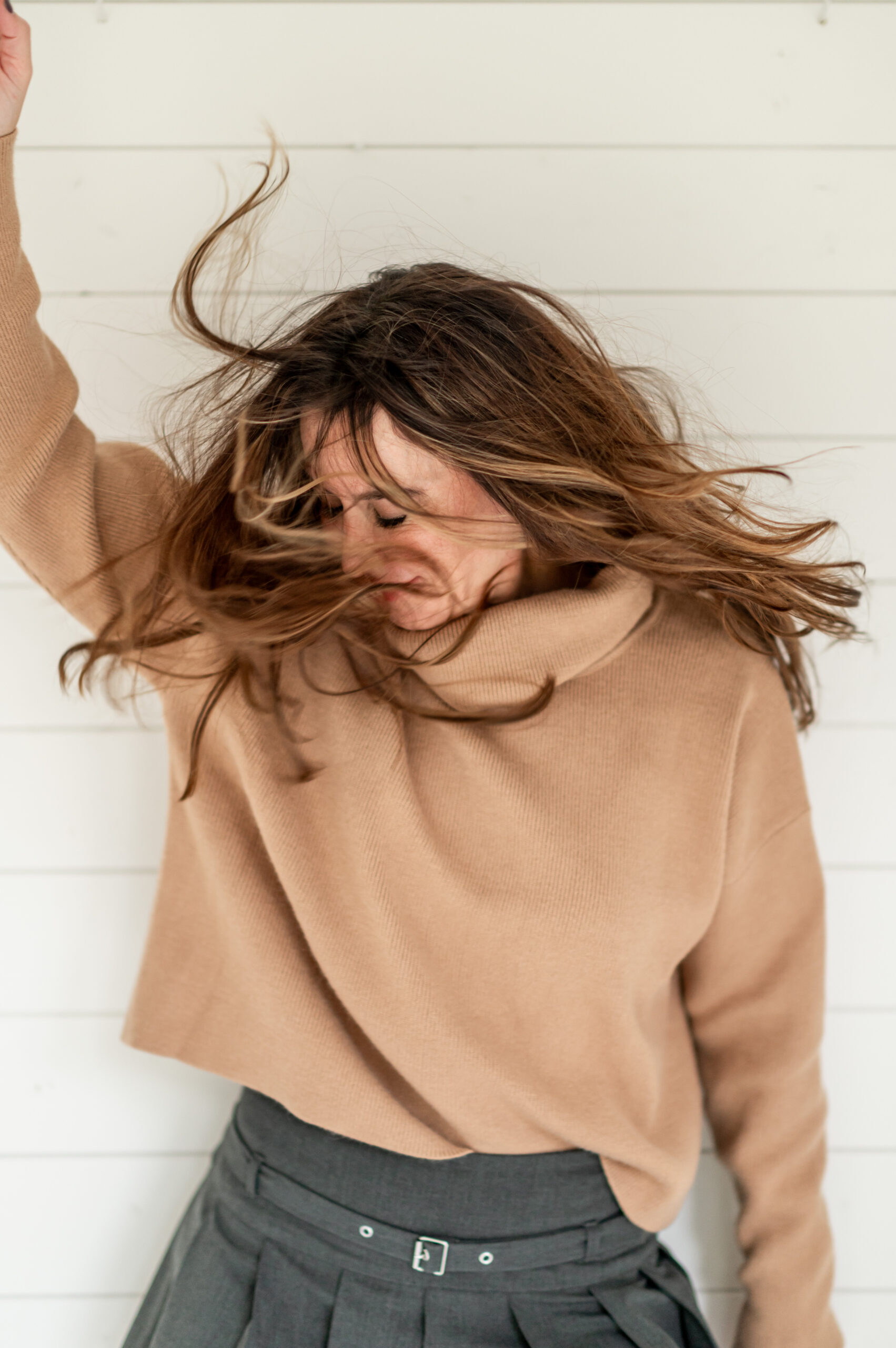 Woman shaking head and hair for her business launch photoshoot