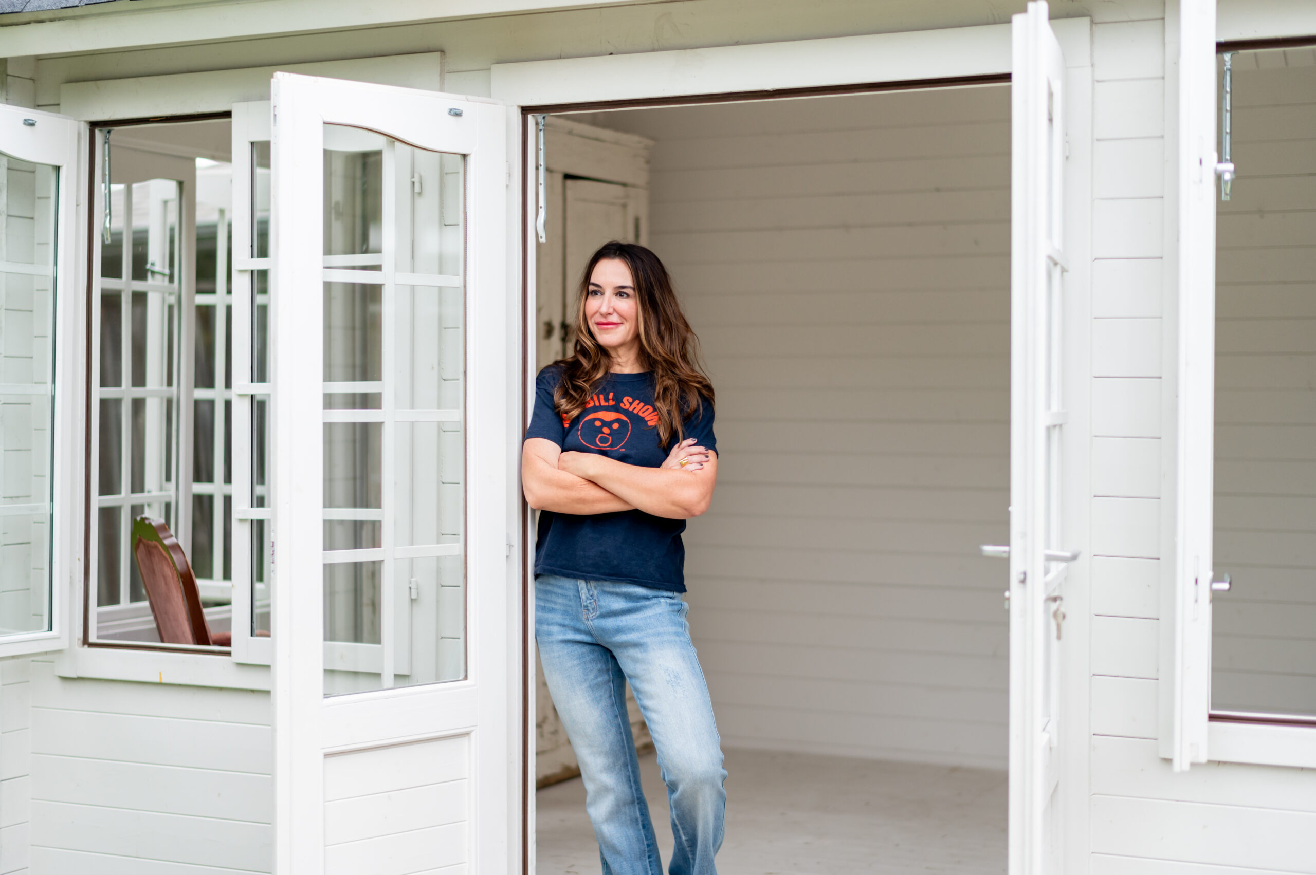 Woman standing posing in door frame for her business launch photoshoot