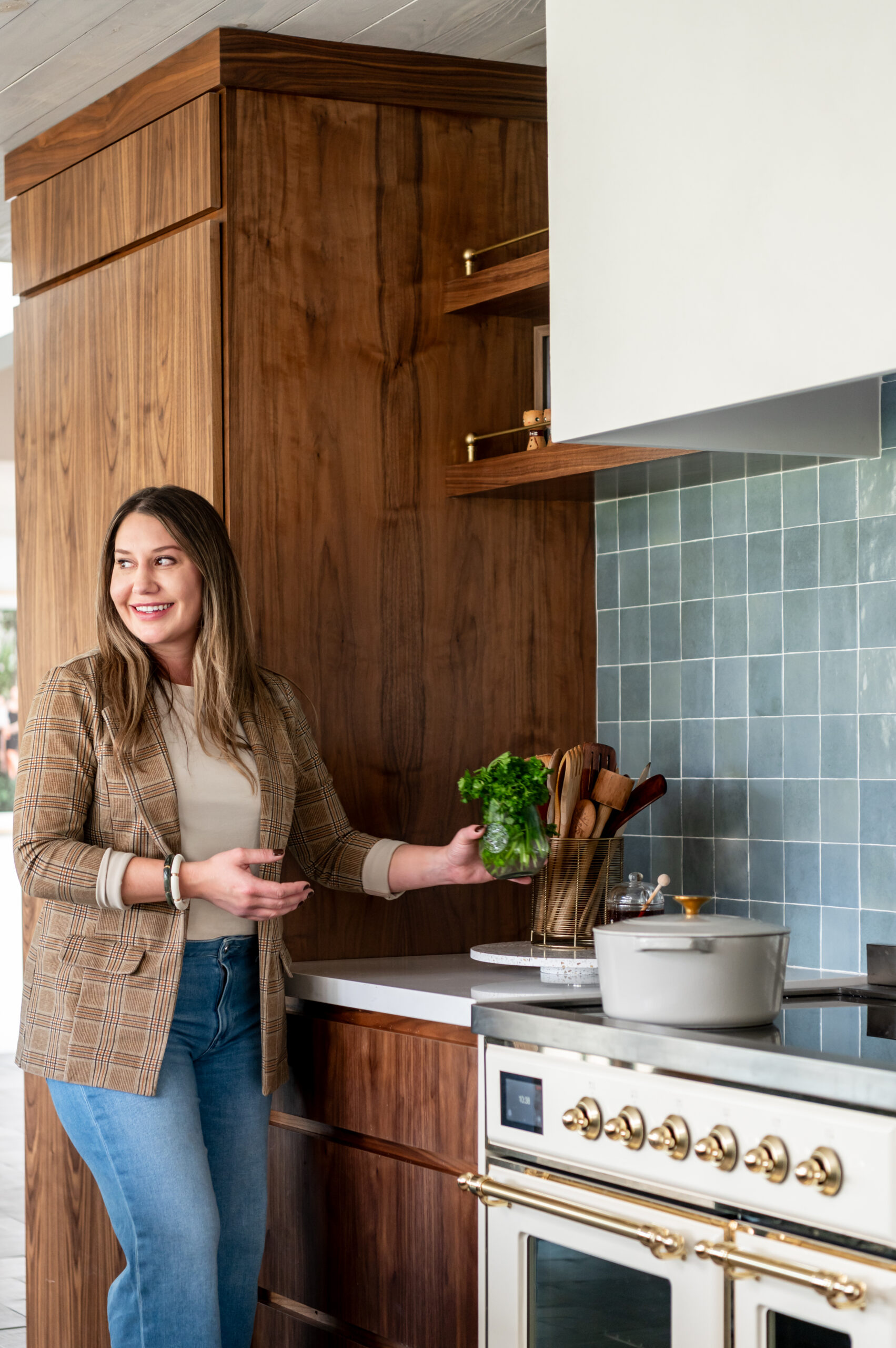 Woman smiling in a beautiful kitchen for her interior design and brand photography shoot