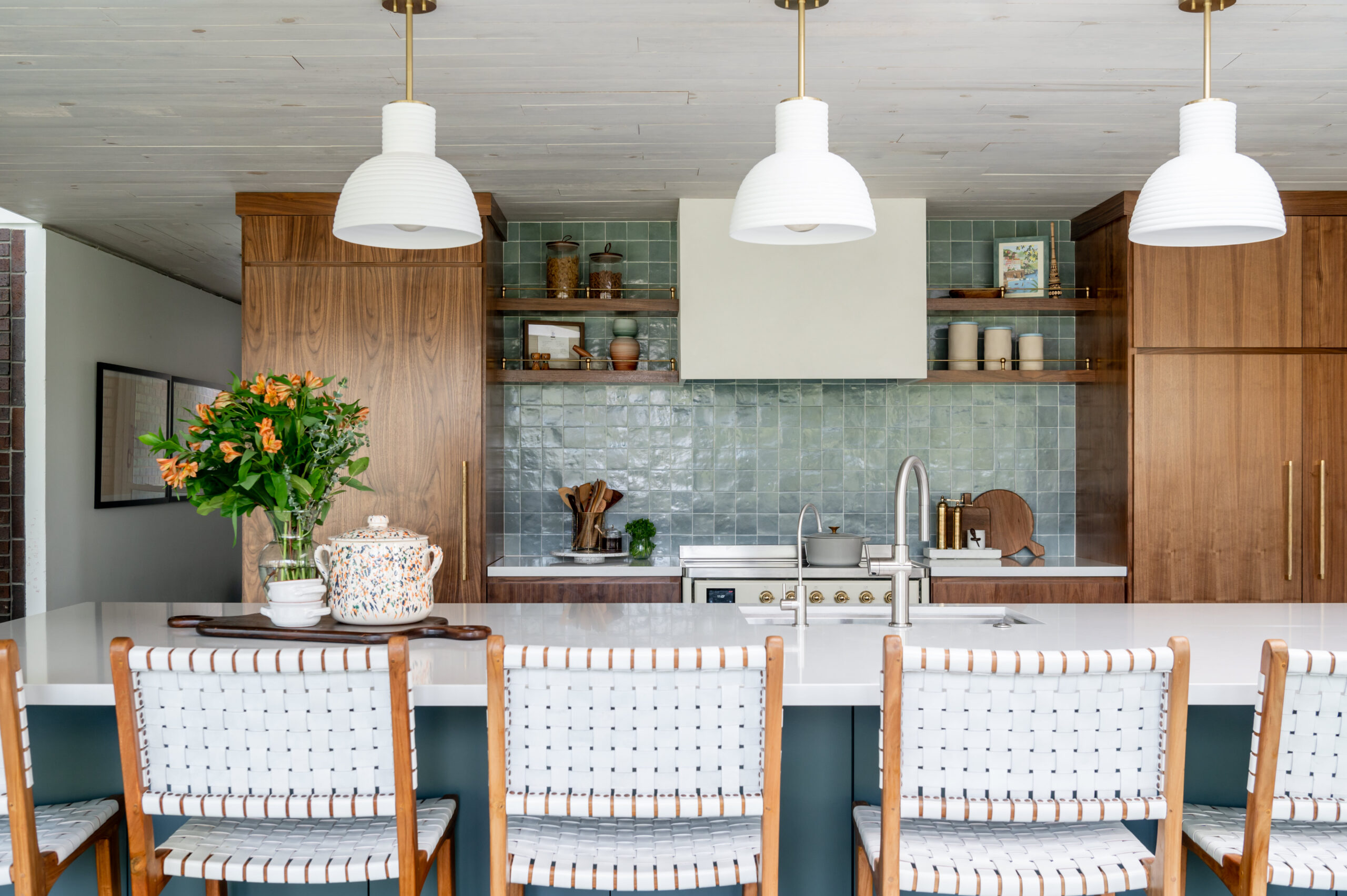 Midcentury kitchen interior design, with tile backsplash and wood cabinets