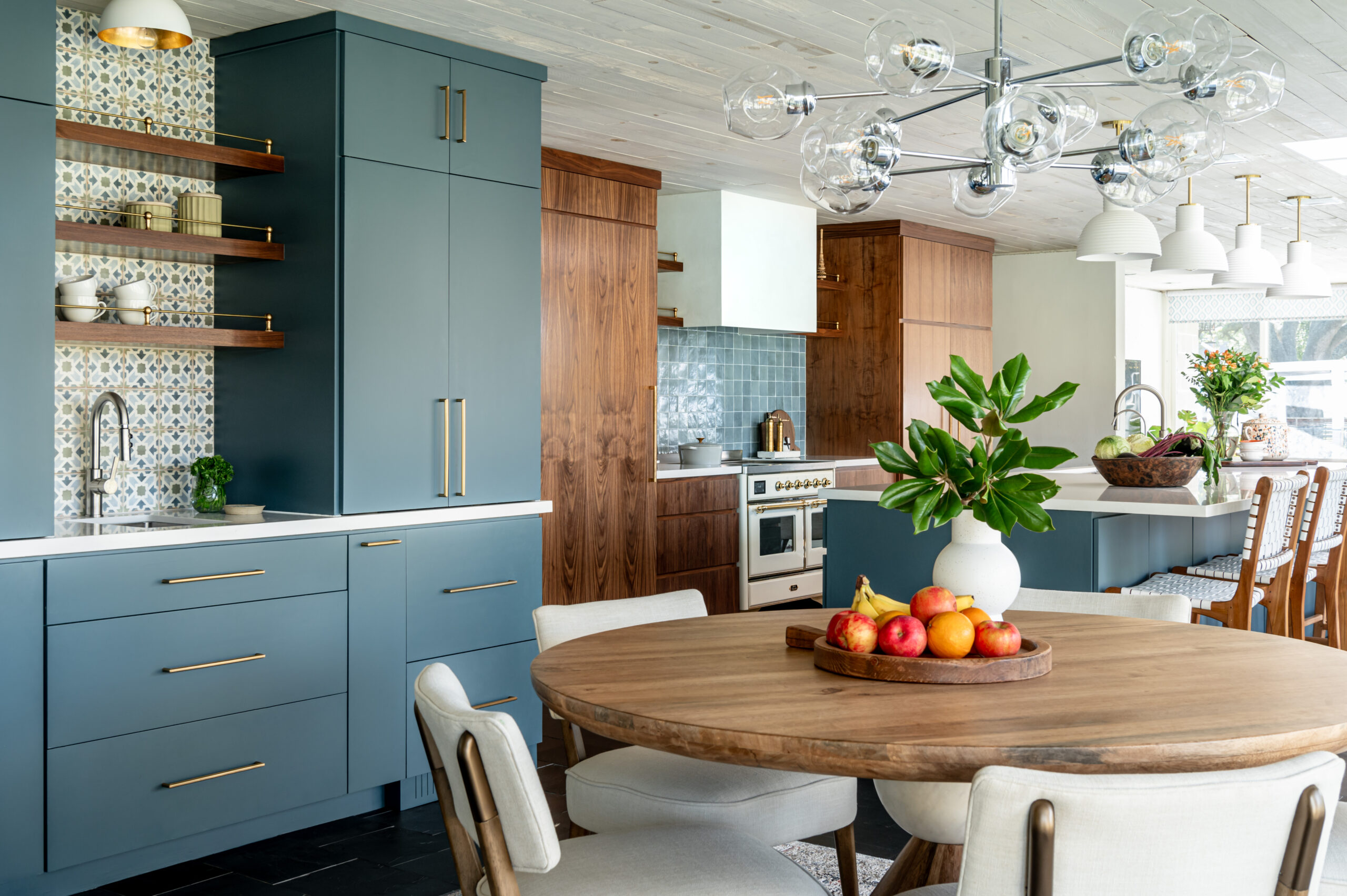 Midcentury kitchen interior design, with tile backsplash, wood cabinets, and blue cabinetry
