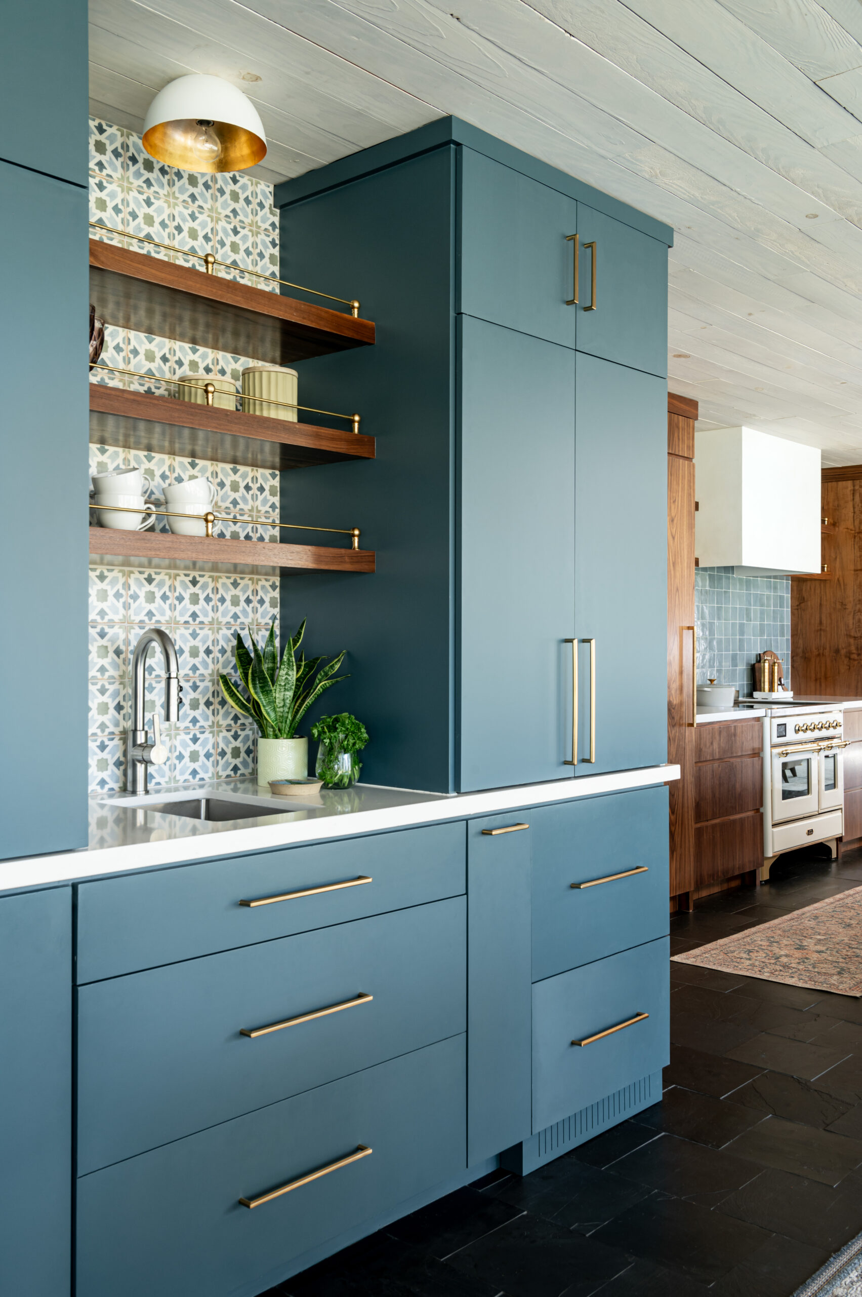 Midcentury kitchen interior design, with blue cabinetry