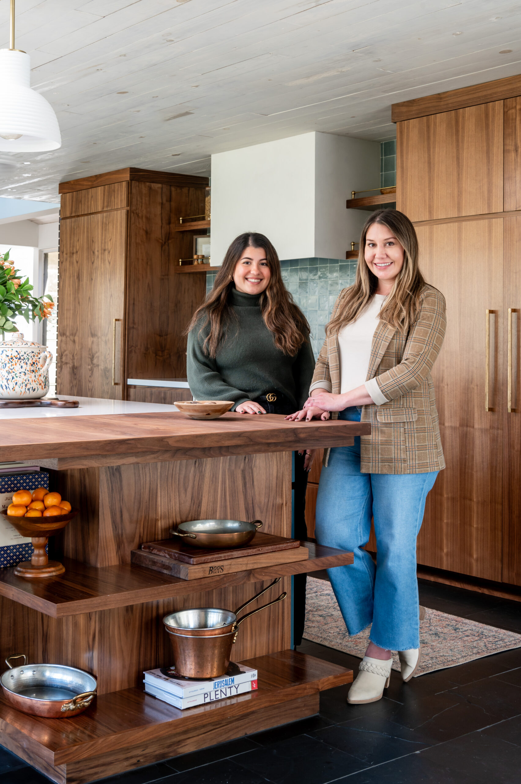 Two women smiling in a beautiful kitchen for her interior design and brand photography shoot