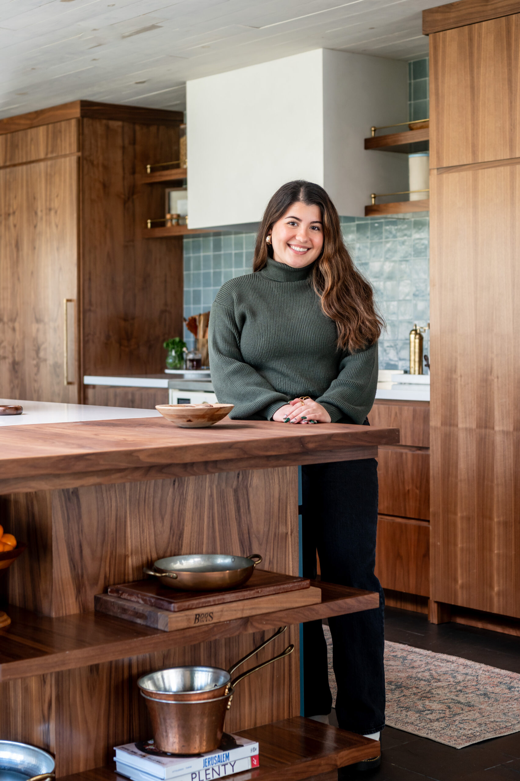 Woman smiling in a beautiful kitchen for her interior design and brand photography shoot