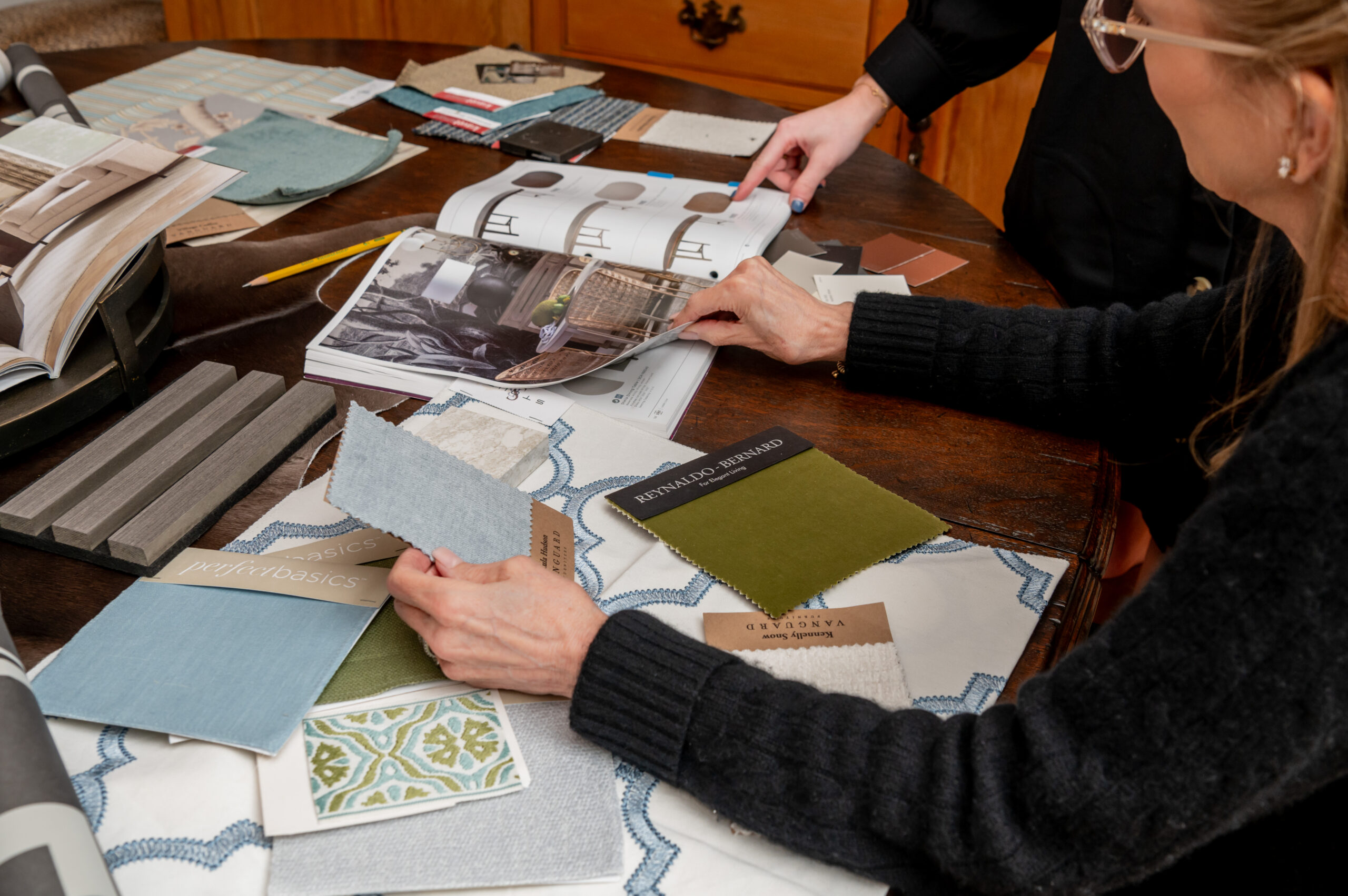 Women planning an interior design project with Textile design layouts of different fabrics